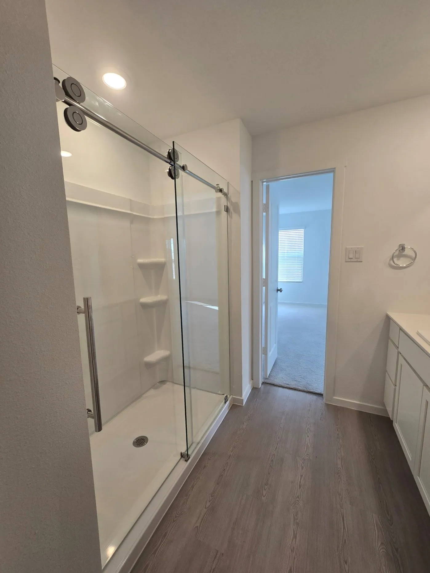 Glass-enclosed Primary Bathroom on 2nd floor - shower with sliding barn-door style with integrated shelving