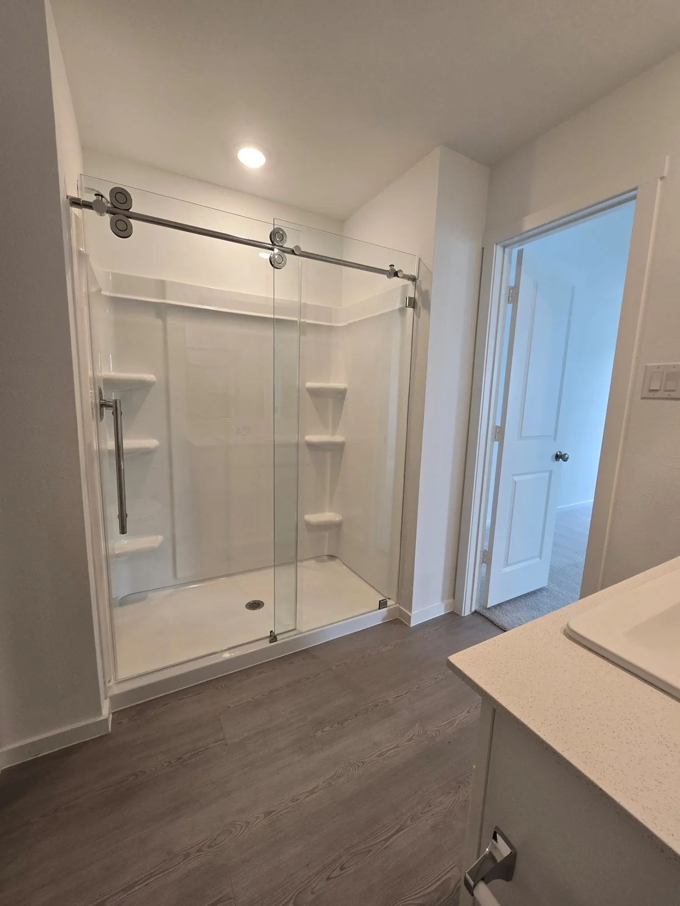 Primary Bathroom on 2nd floor - Glass-enclosed shower with sliding barn-door style with integrated shelving