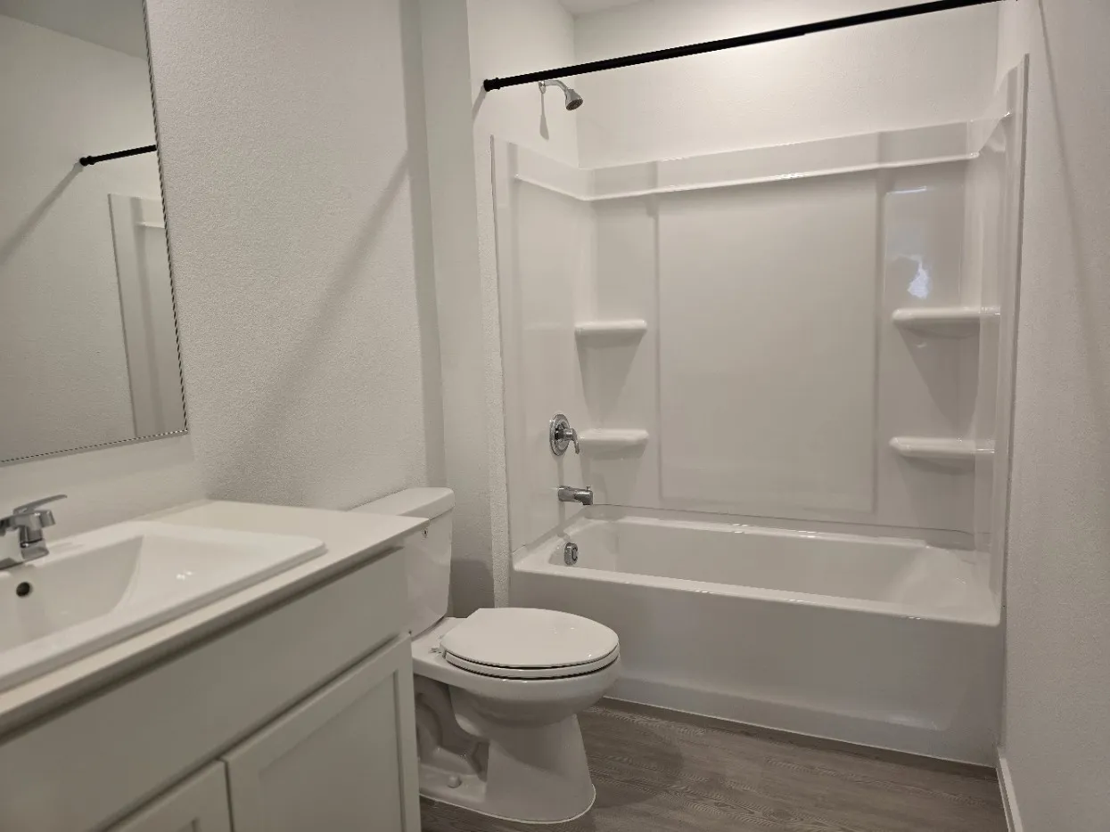 Bathroom on 2nd floor. White quartz counter vanity with a single basin sink, chrome faucet, and a large mirror