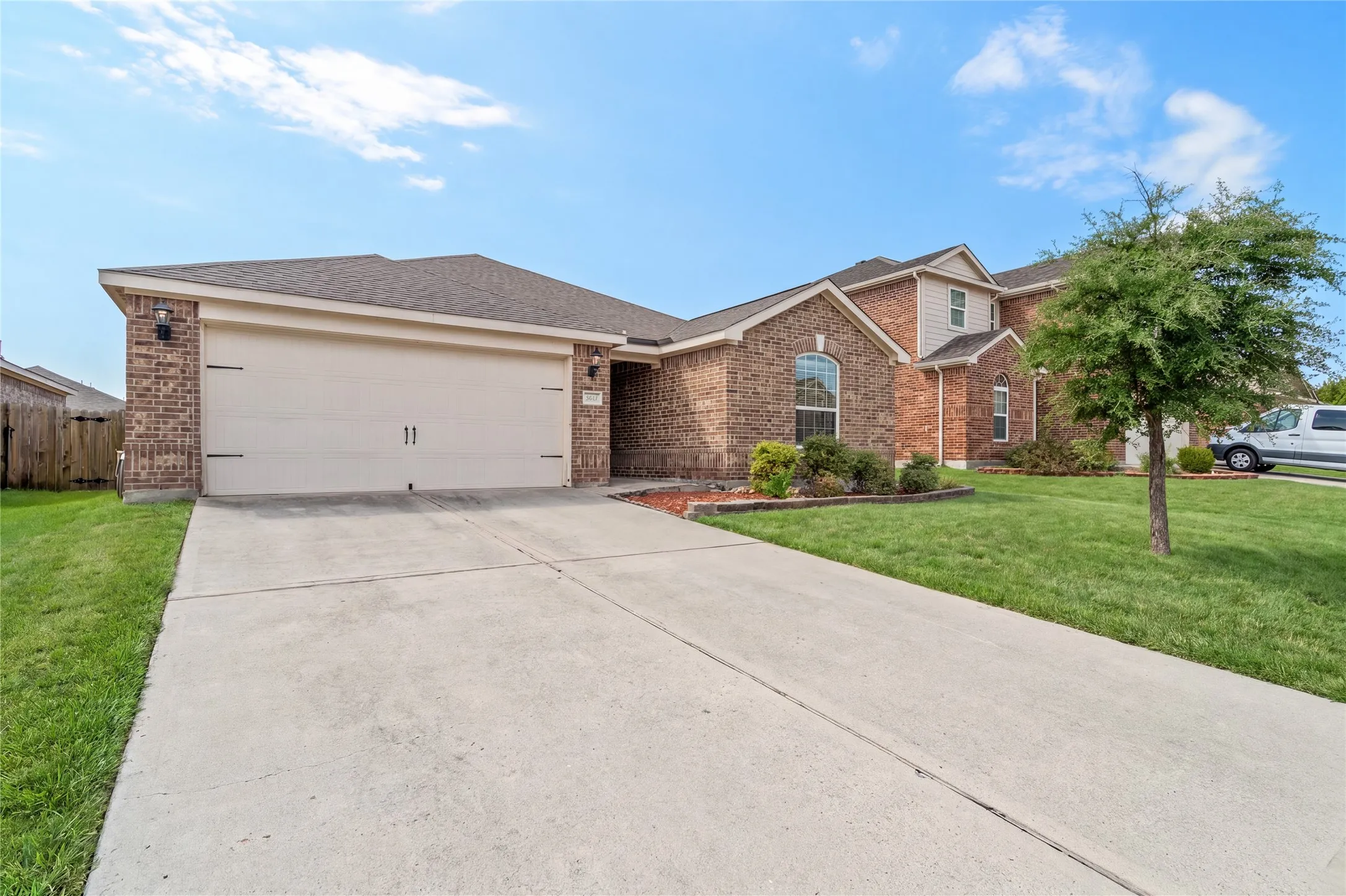 Brick exterior with a gabled roofline and attached garage
