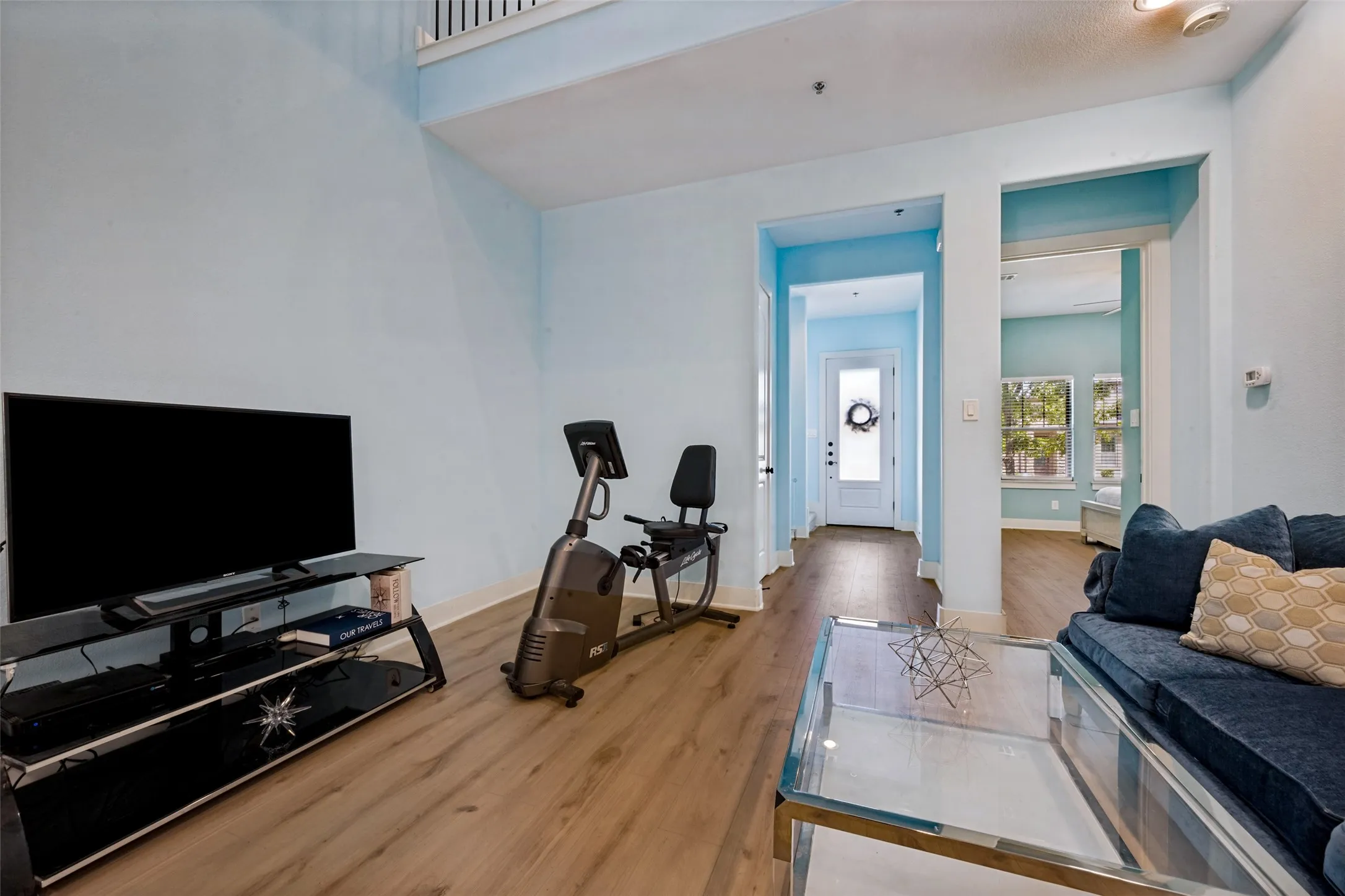 NEW LVP flooring throughout, two-story ceiling, recessed lighting, and white trim