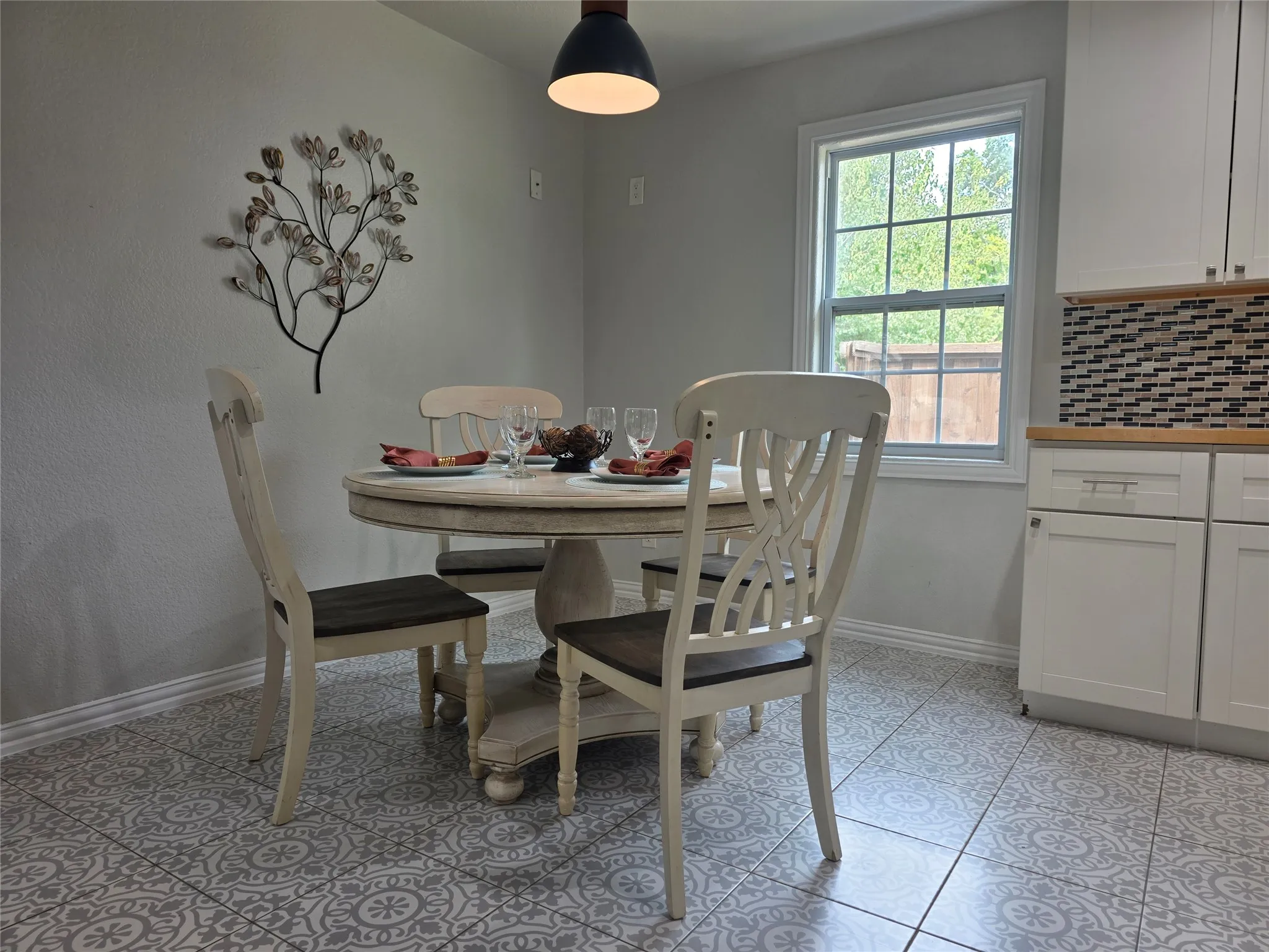 Patterned floor tiling in this elegant kitchen and dining area