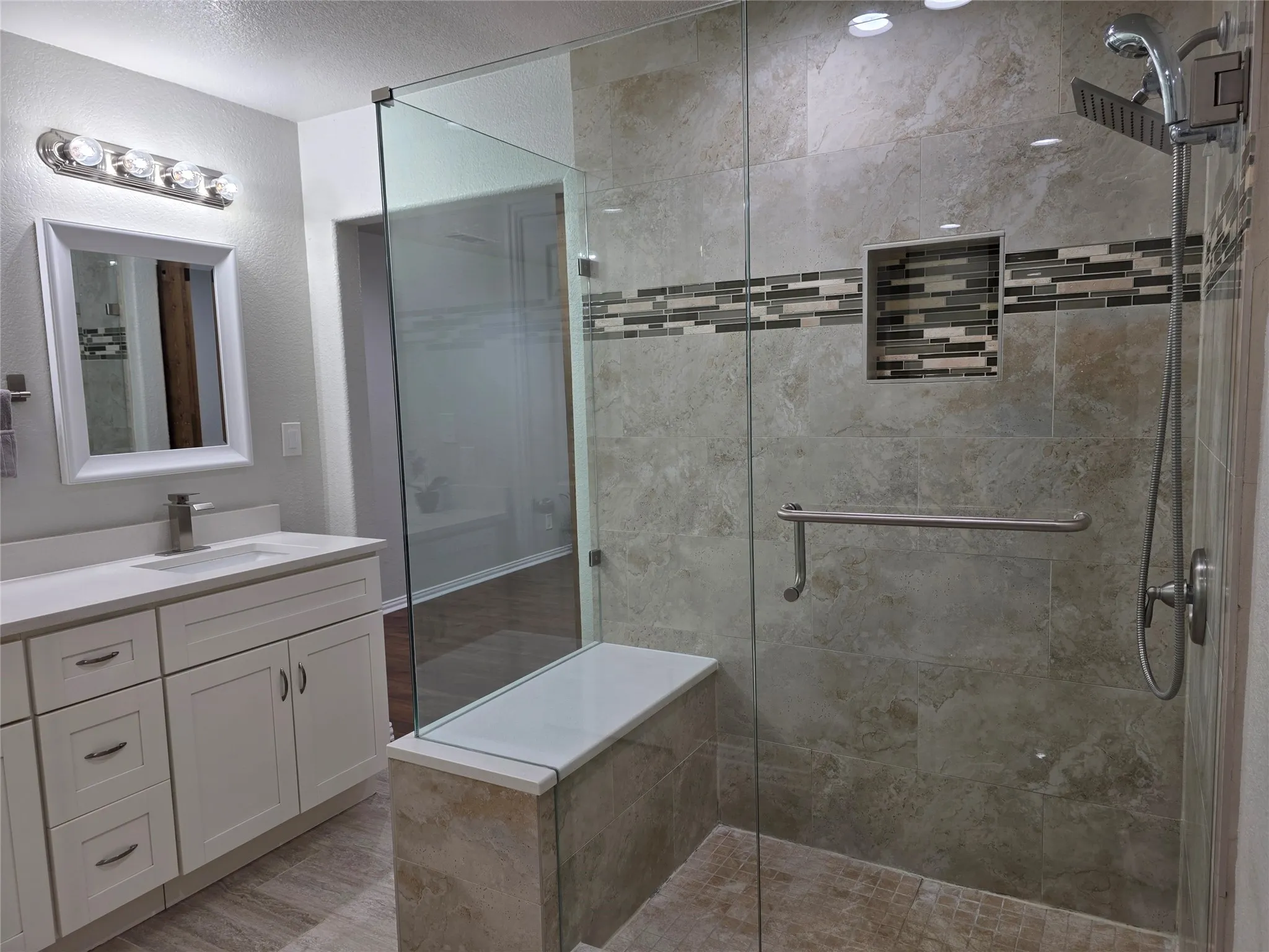 Frameless glass shower with a built-in bench