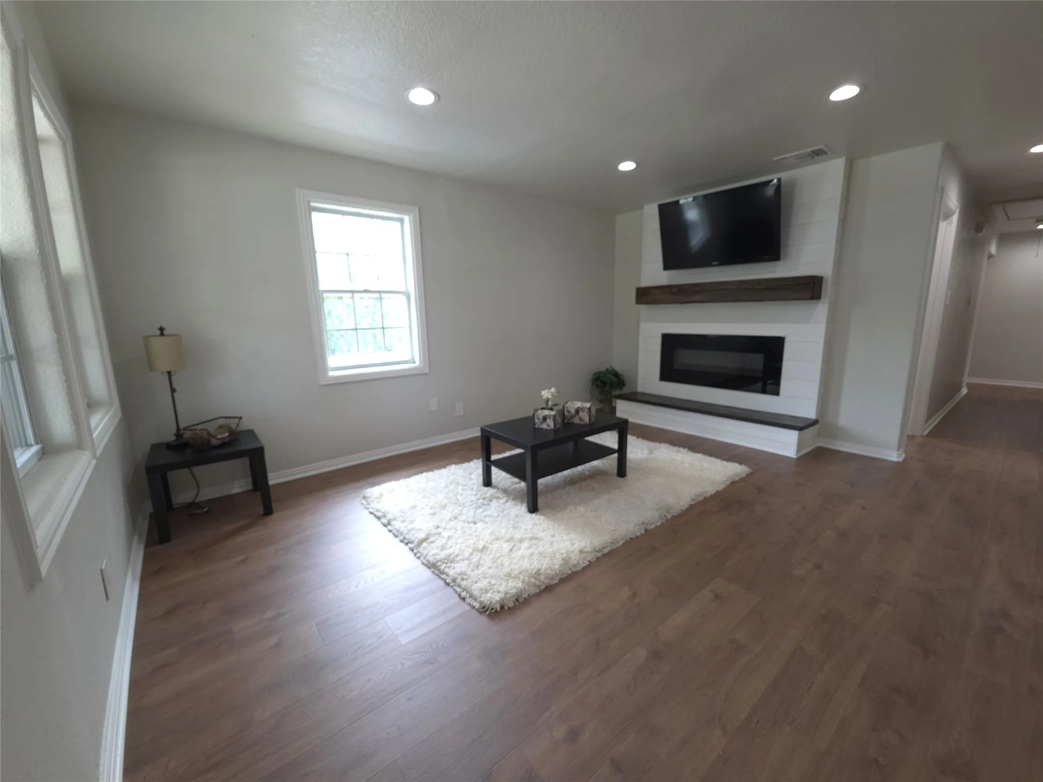 Welcome into this bright living room with a beautiful fireplace accent wall
