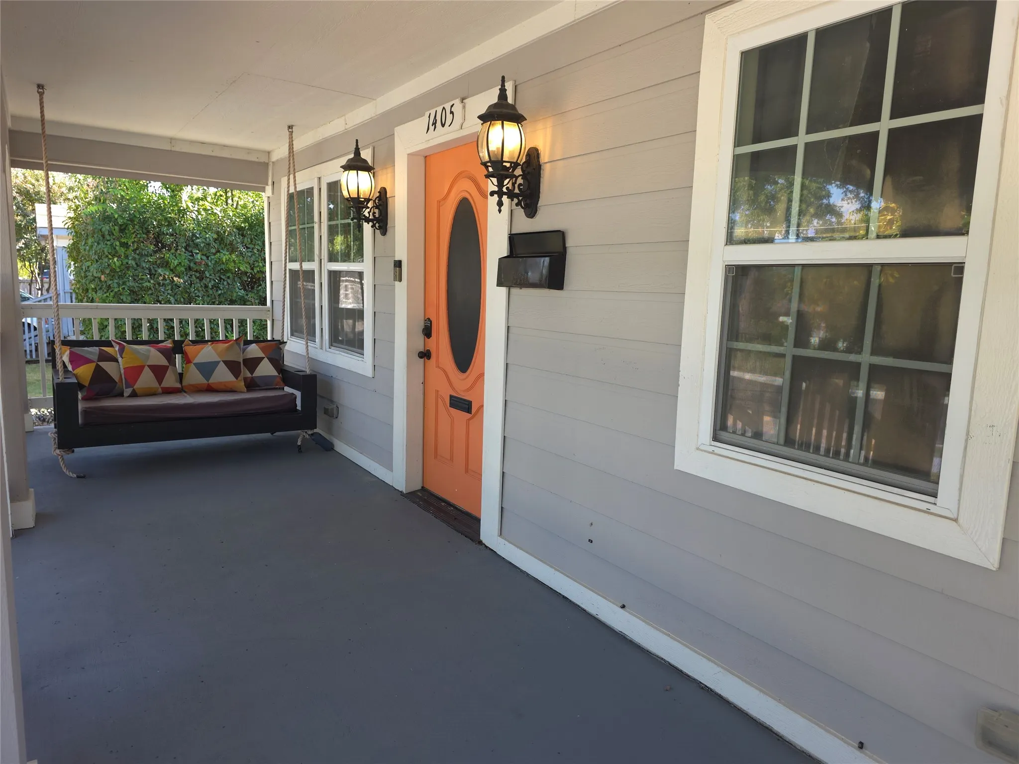 Covered front porch with cozy swing for morning coffee