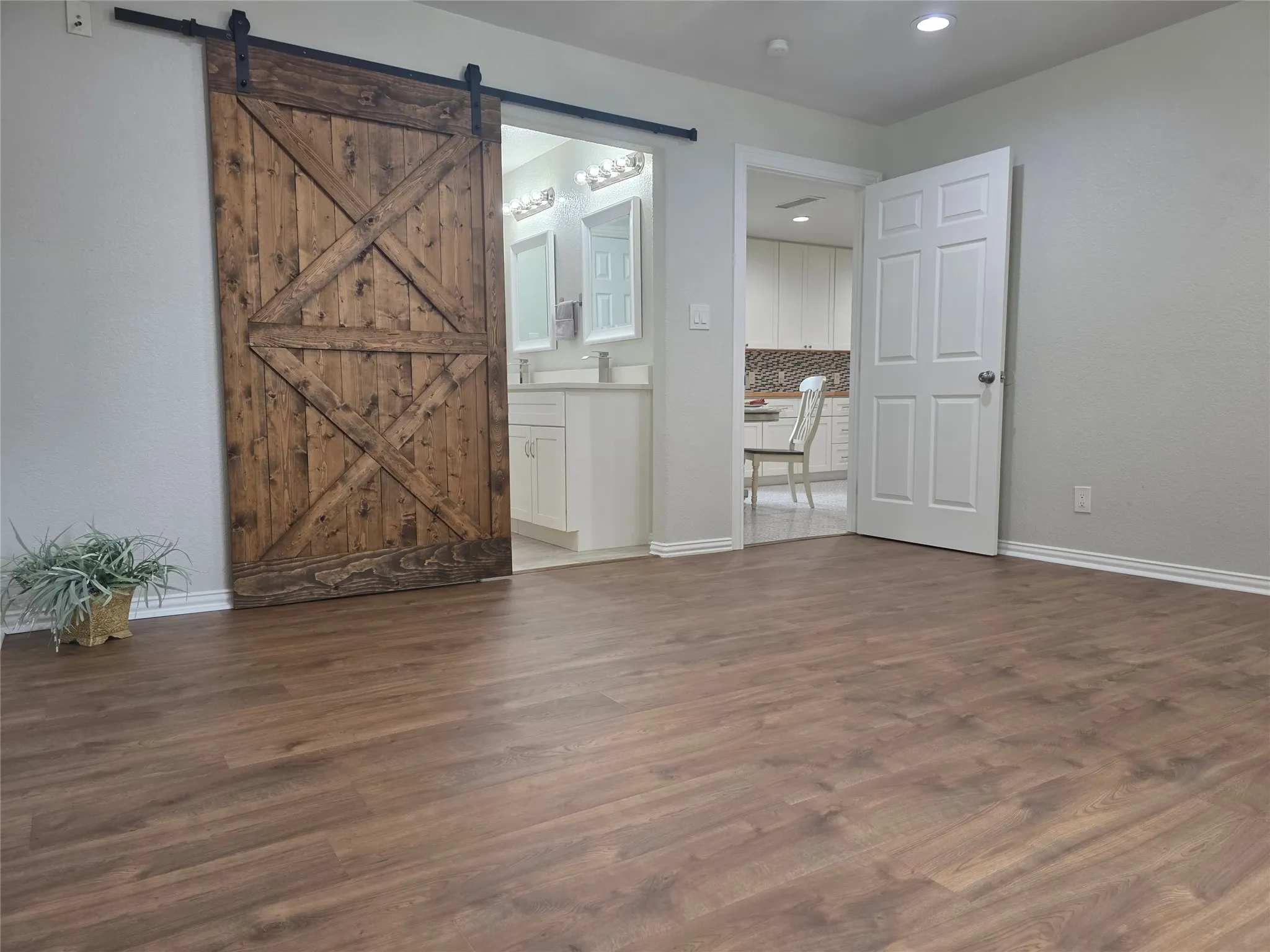 Barn door leading into the en-suite bathroom