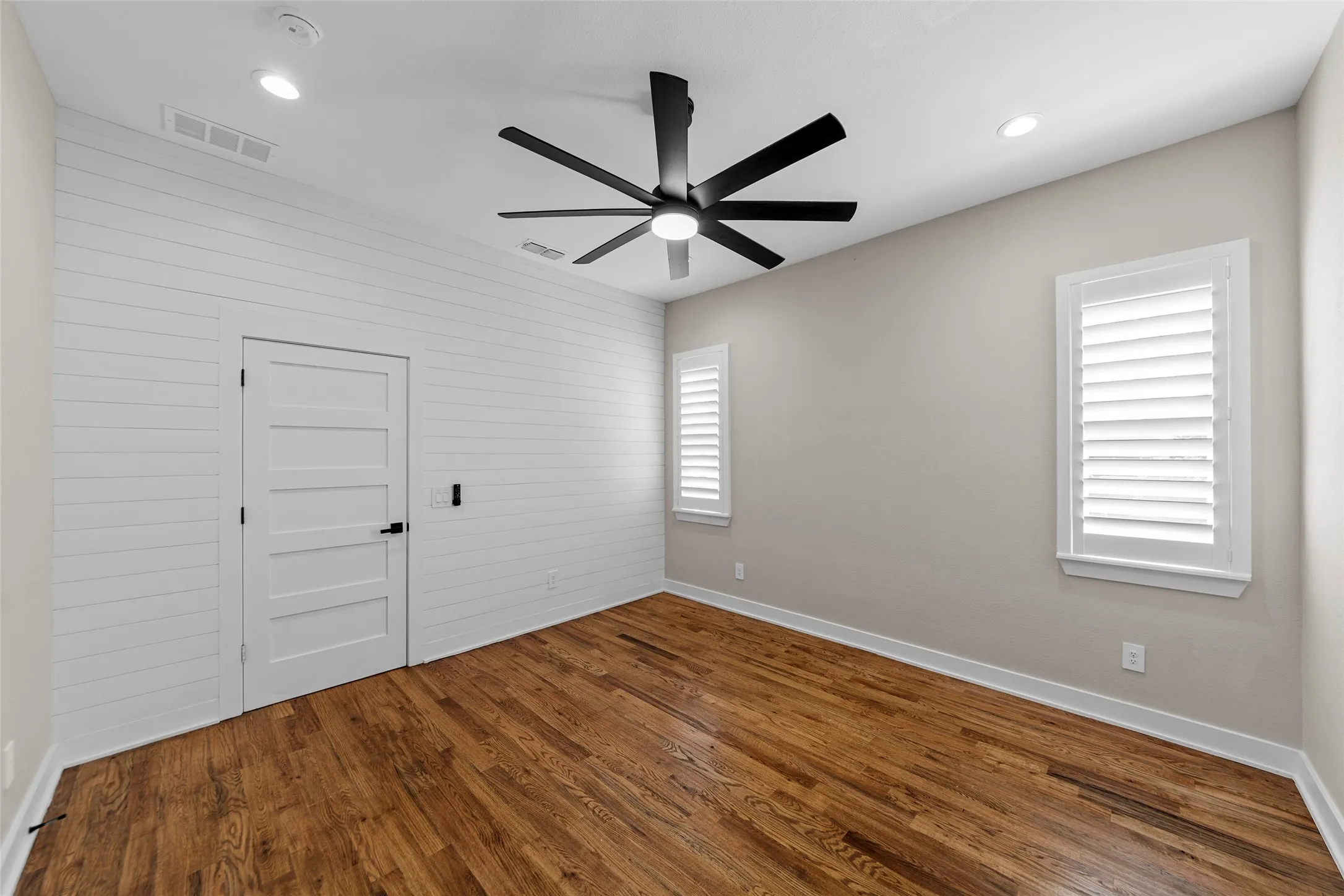 Shiplap accent wall in primary bedroom