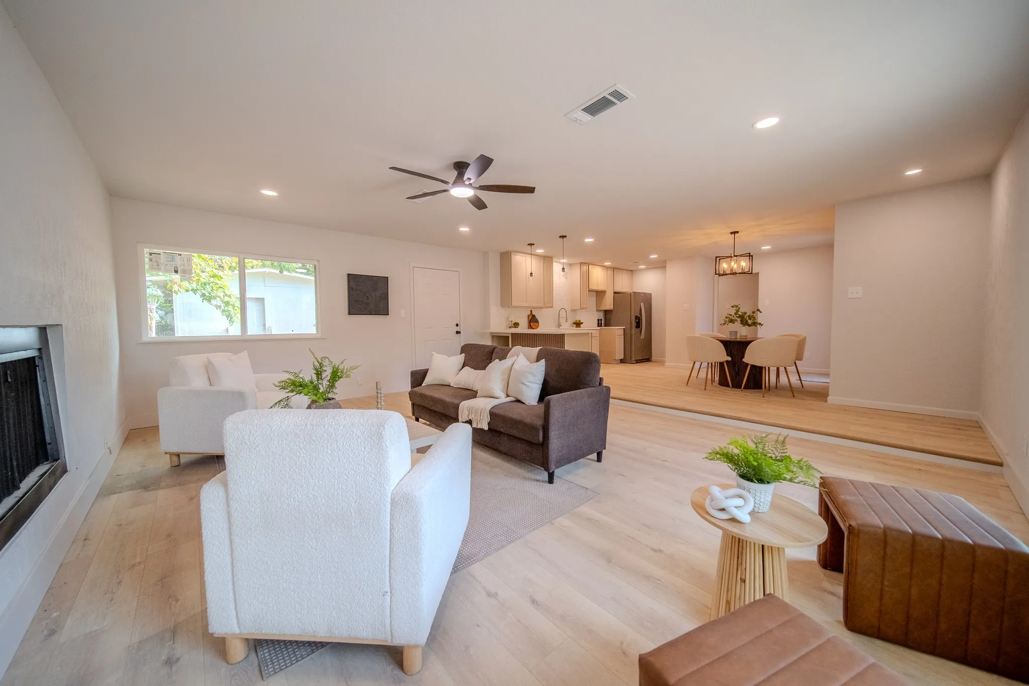 Open-concept living space featuring wood-finish flooring, recessed lighting, and a ceiling fan