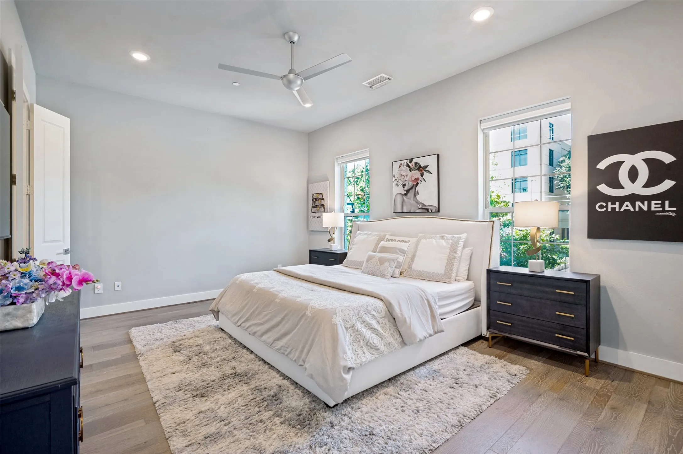 Spacious master suite with wood floors and lots of windows for natural light