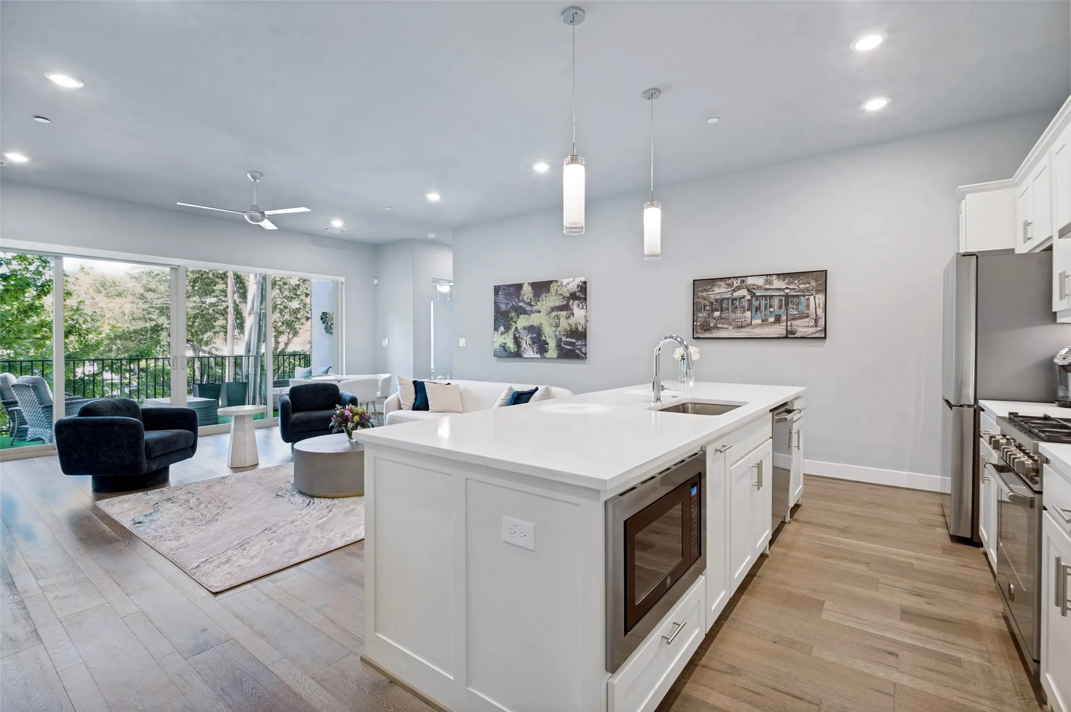 Open-concept layout featuring wood-finish flooring, recessed lighting, and a modern ceiling fan