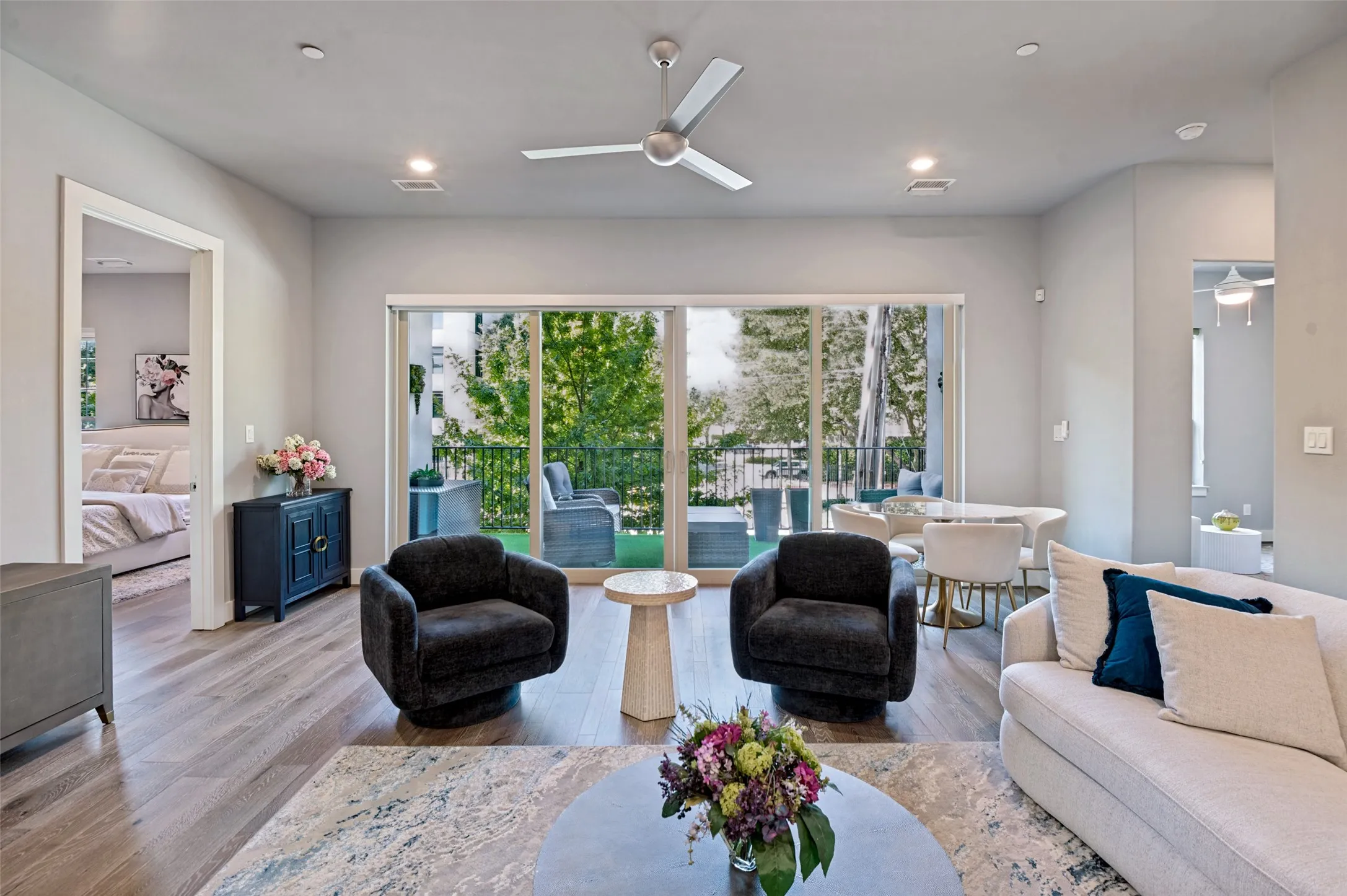 Slidin glass doors open to the terrace overlooking the tree-lined pavestone sidewalks of Addison Circle