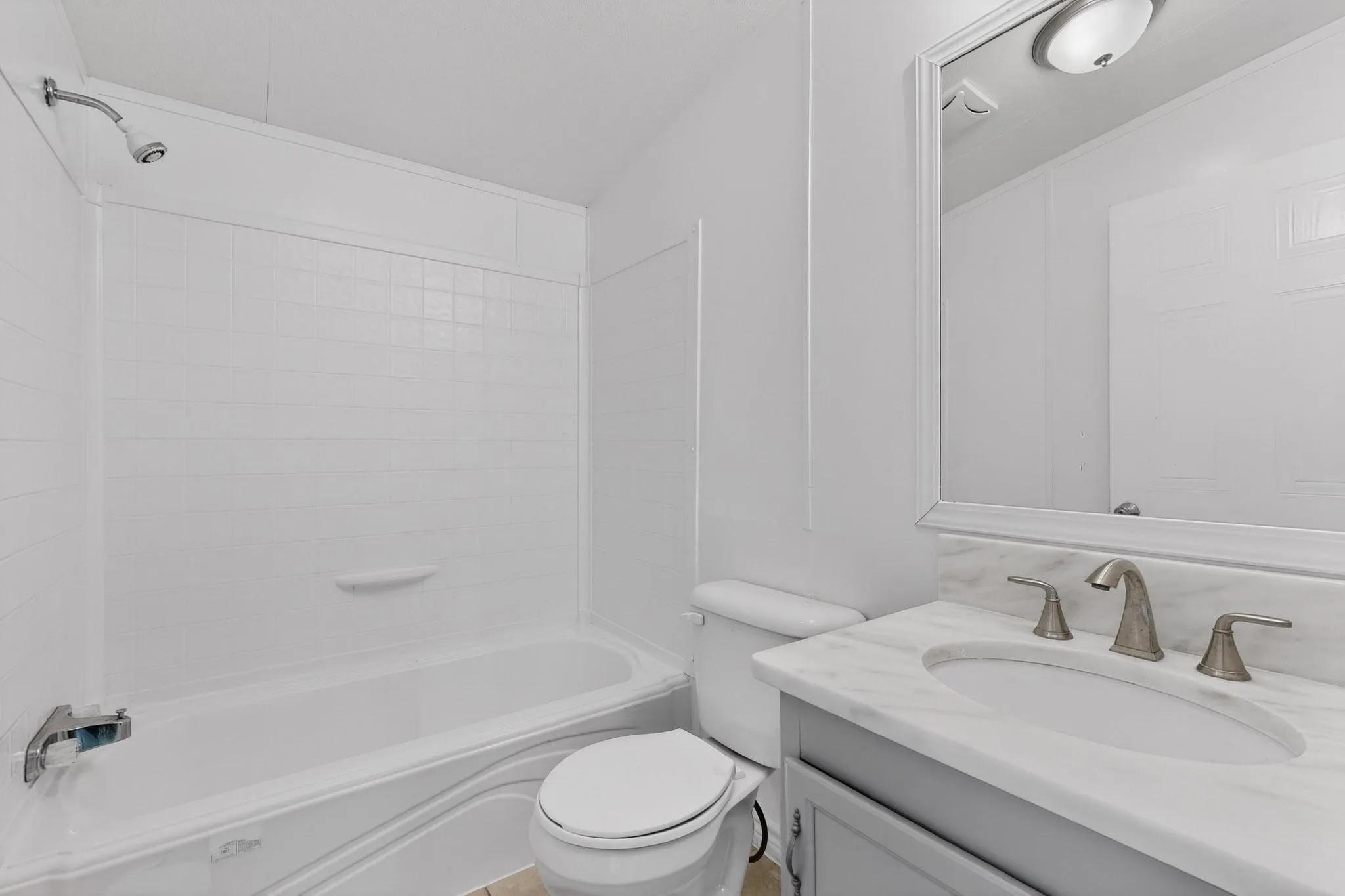 Bathroom with vanity and  shower combination