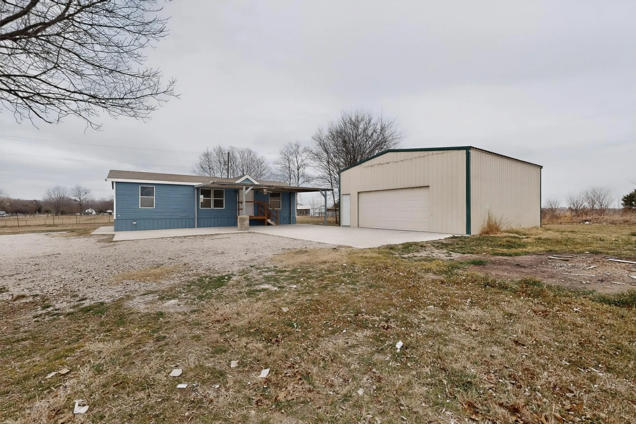 View of front facade featuring an outdoor structure and a garage