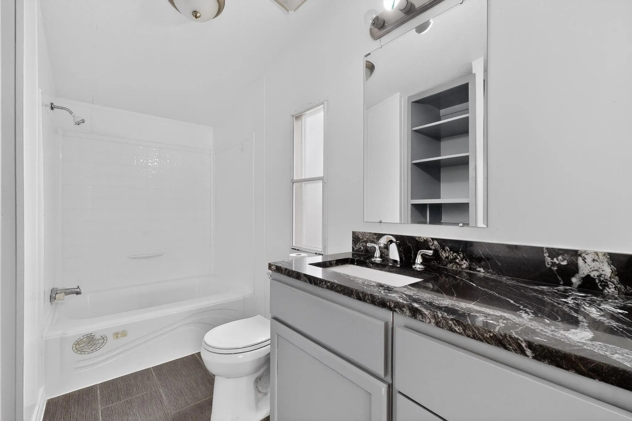 Full bath with vanity and tub / shower combination