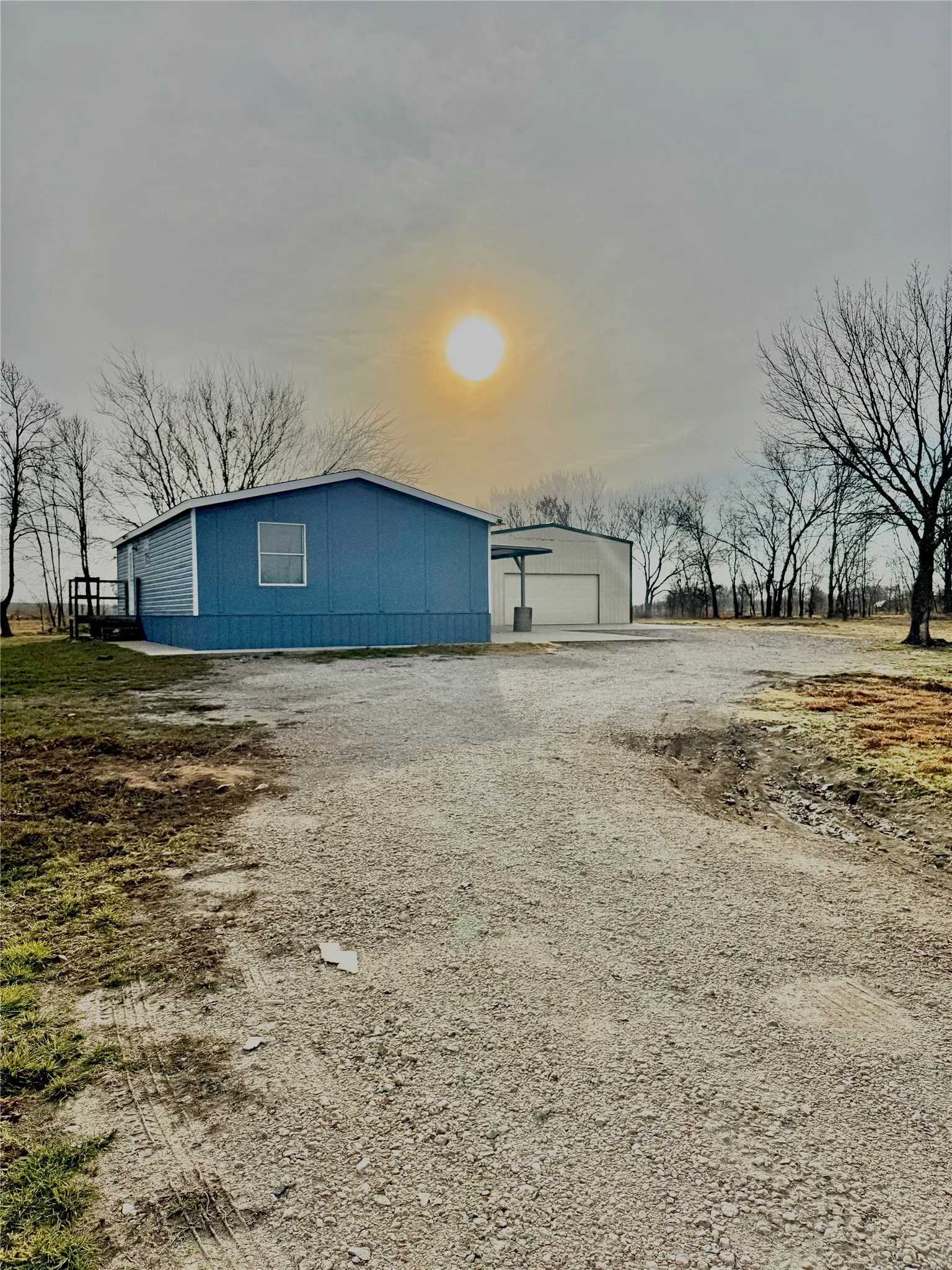 View of outdoor structure featuring driveway