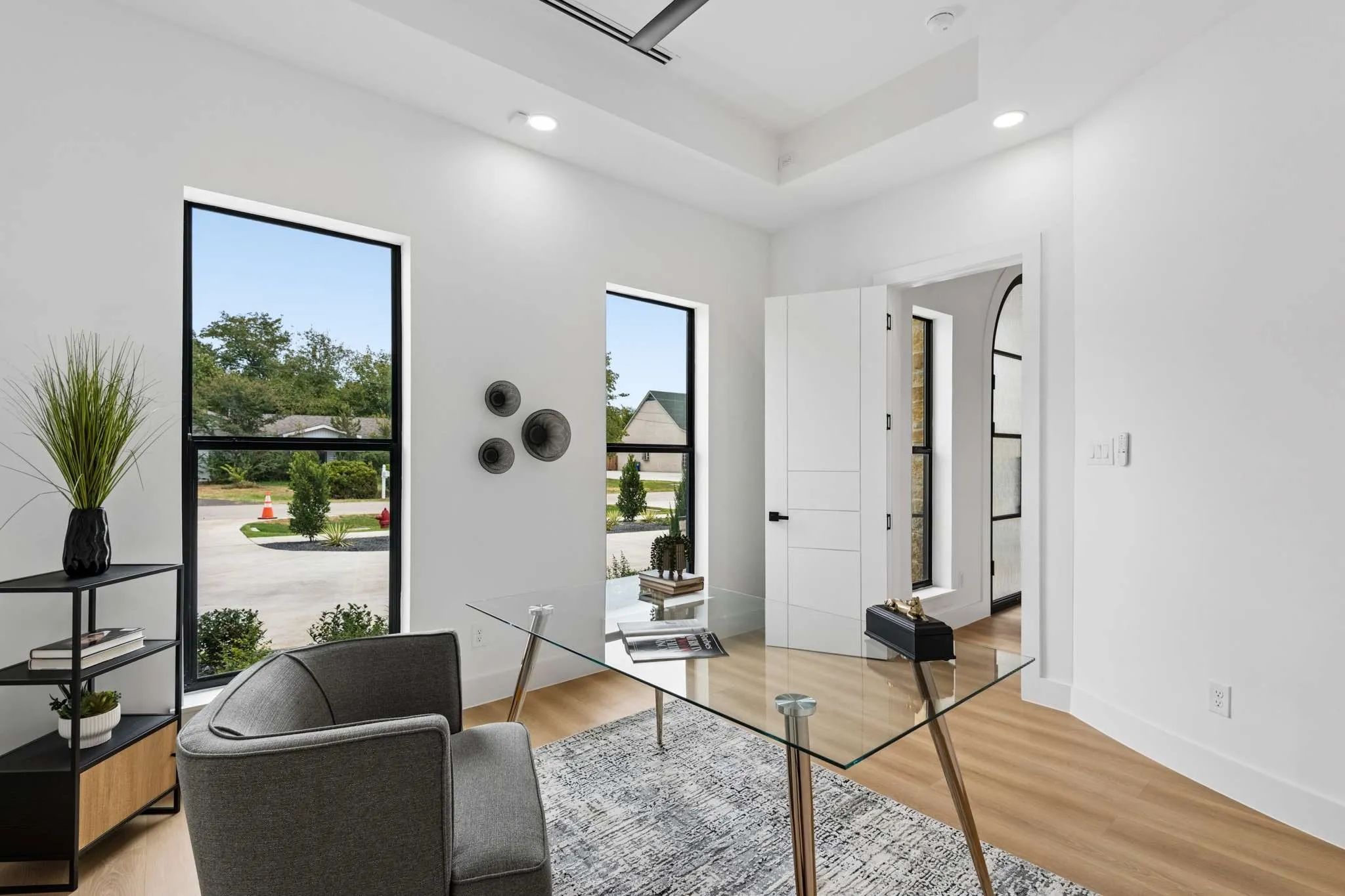 Recessed lighting, light wood-finish flooring, and a tray ceiling