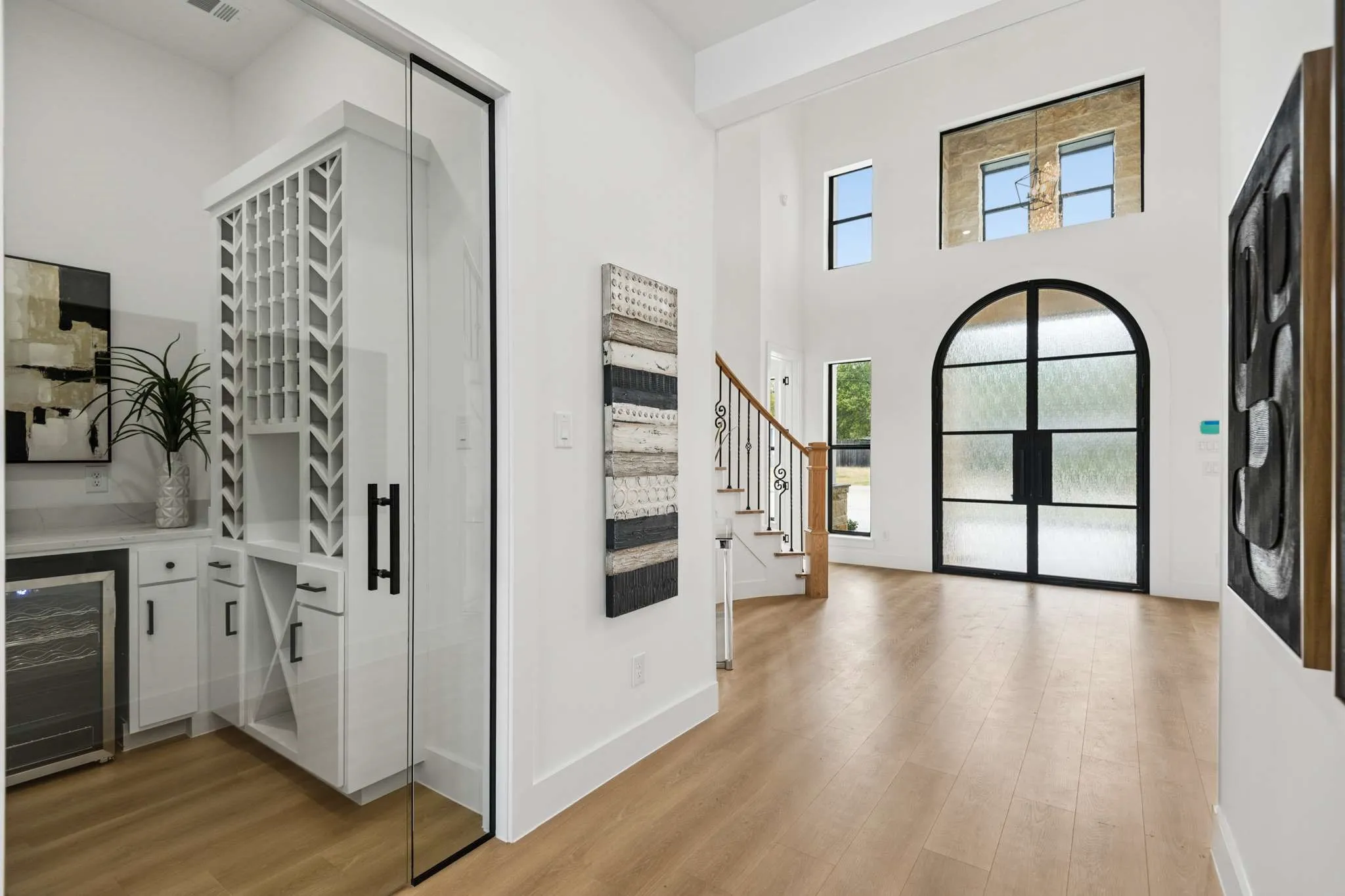 Double-height foyer with wood-finish flooring