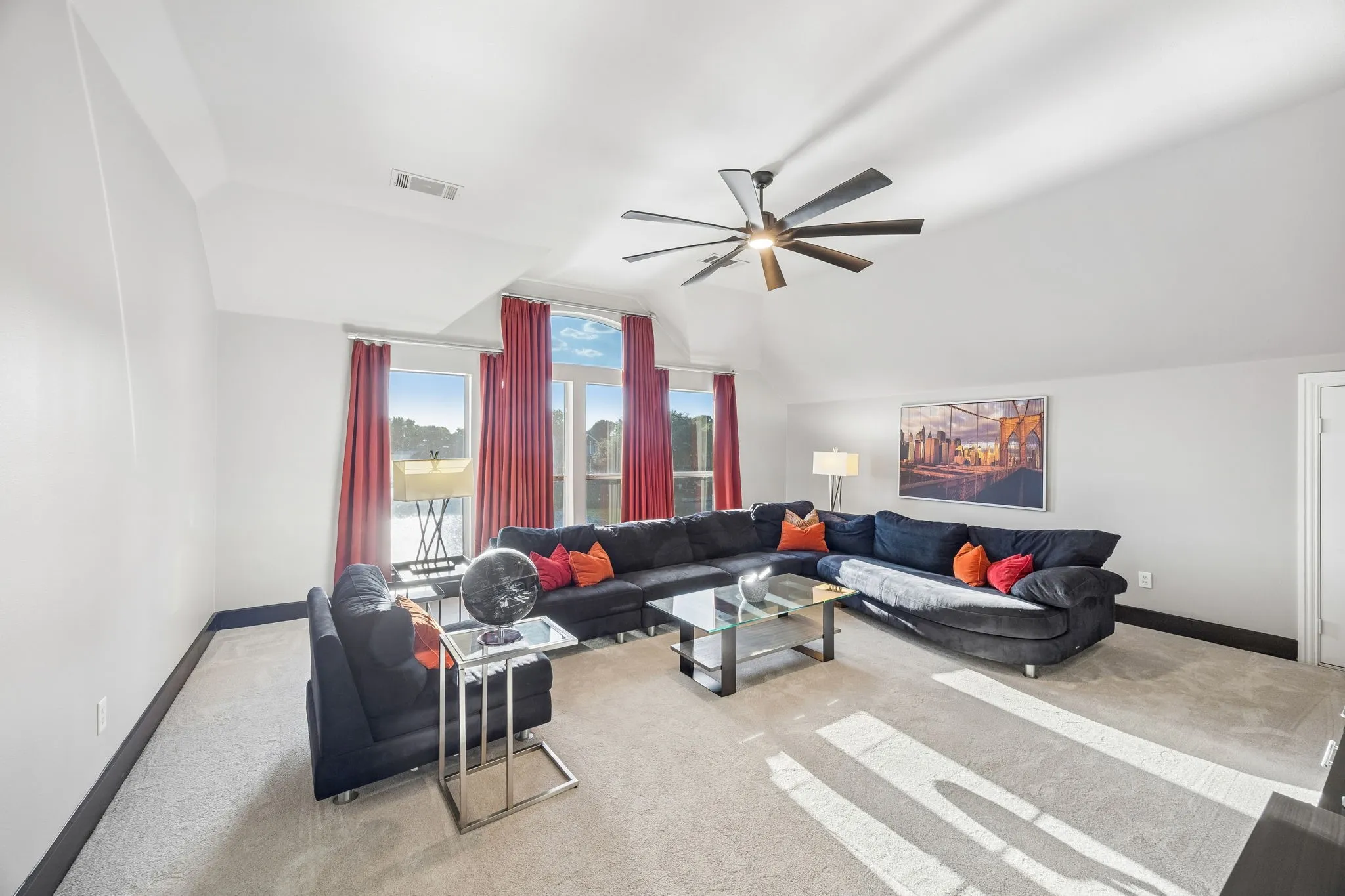 Spacious second living/game room with vaulted ceilings and abundant natural light is accompanied by two secondary bedrooms and a full bath, creating a flexible space for guests, family, movies, or recreation.
