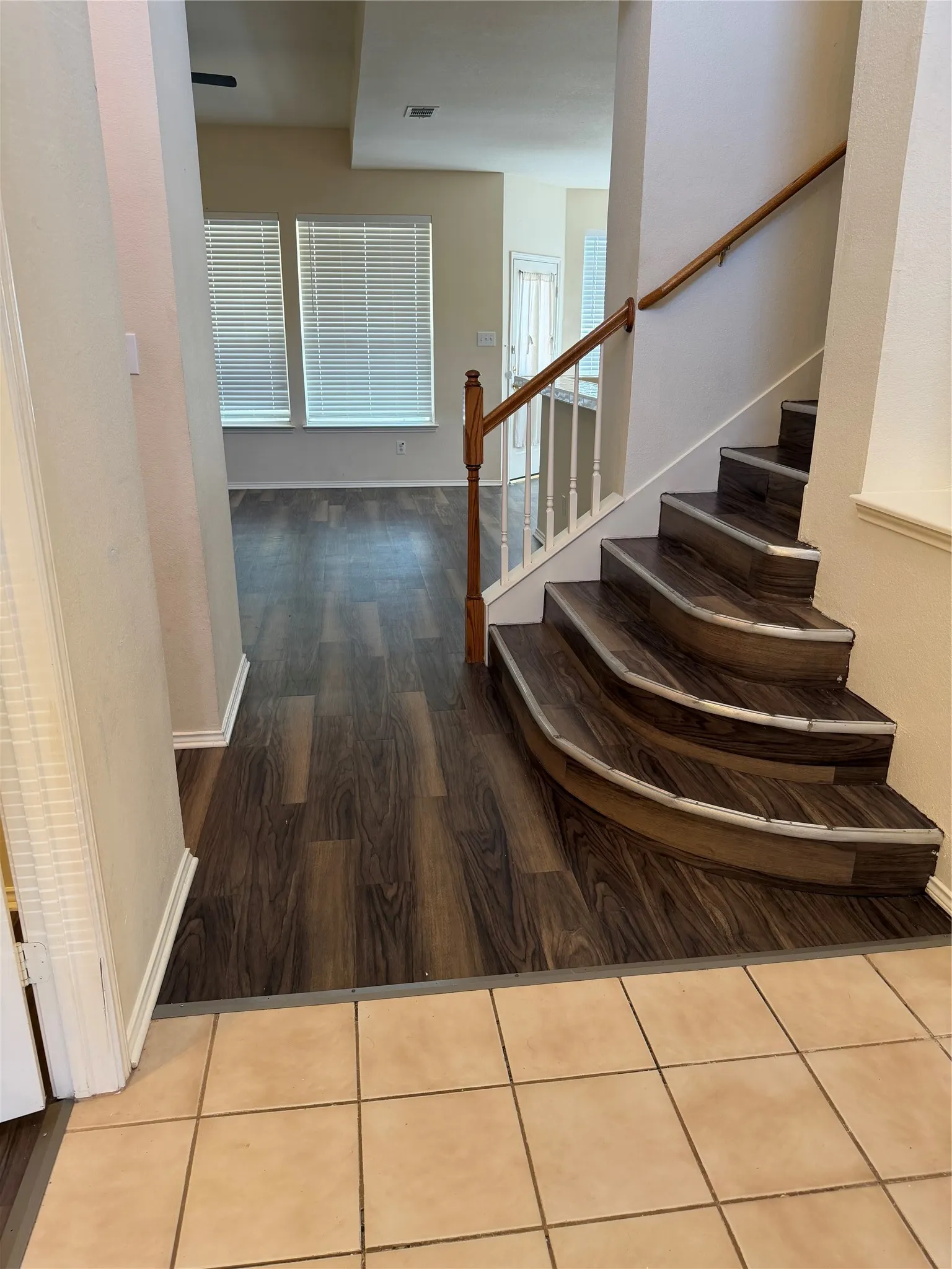 Wood-finish flooring throughout, complemented by a light-toned tile entry