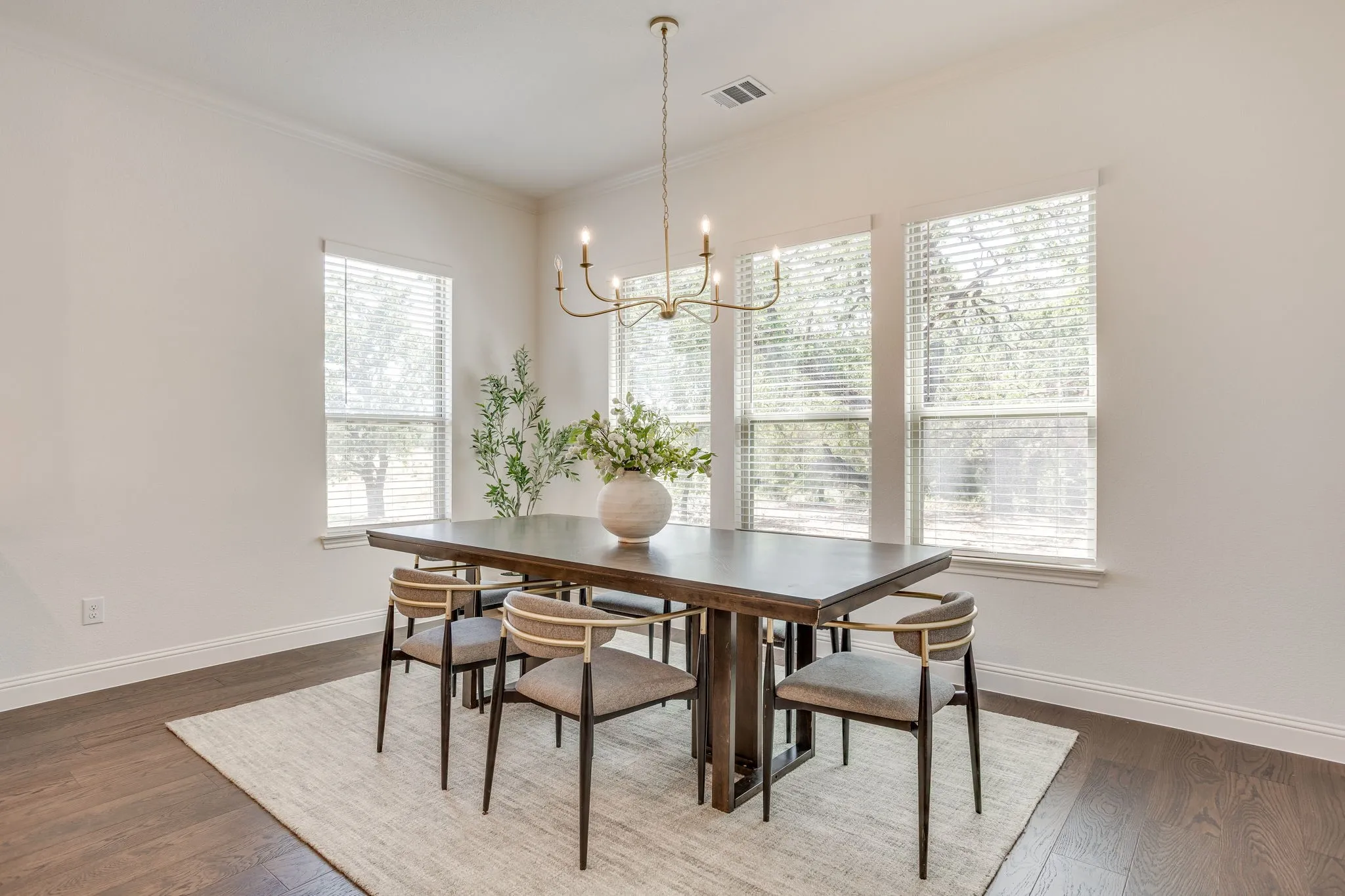 Dining area with wood-finish flooring, white walls, and crown​​‌​​​​‌​​‌‌​‌‌​​​‌‌​‌​‌​‌​​​‌​​ molding