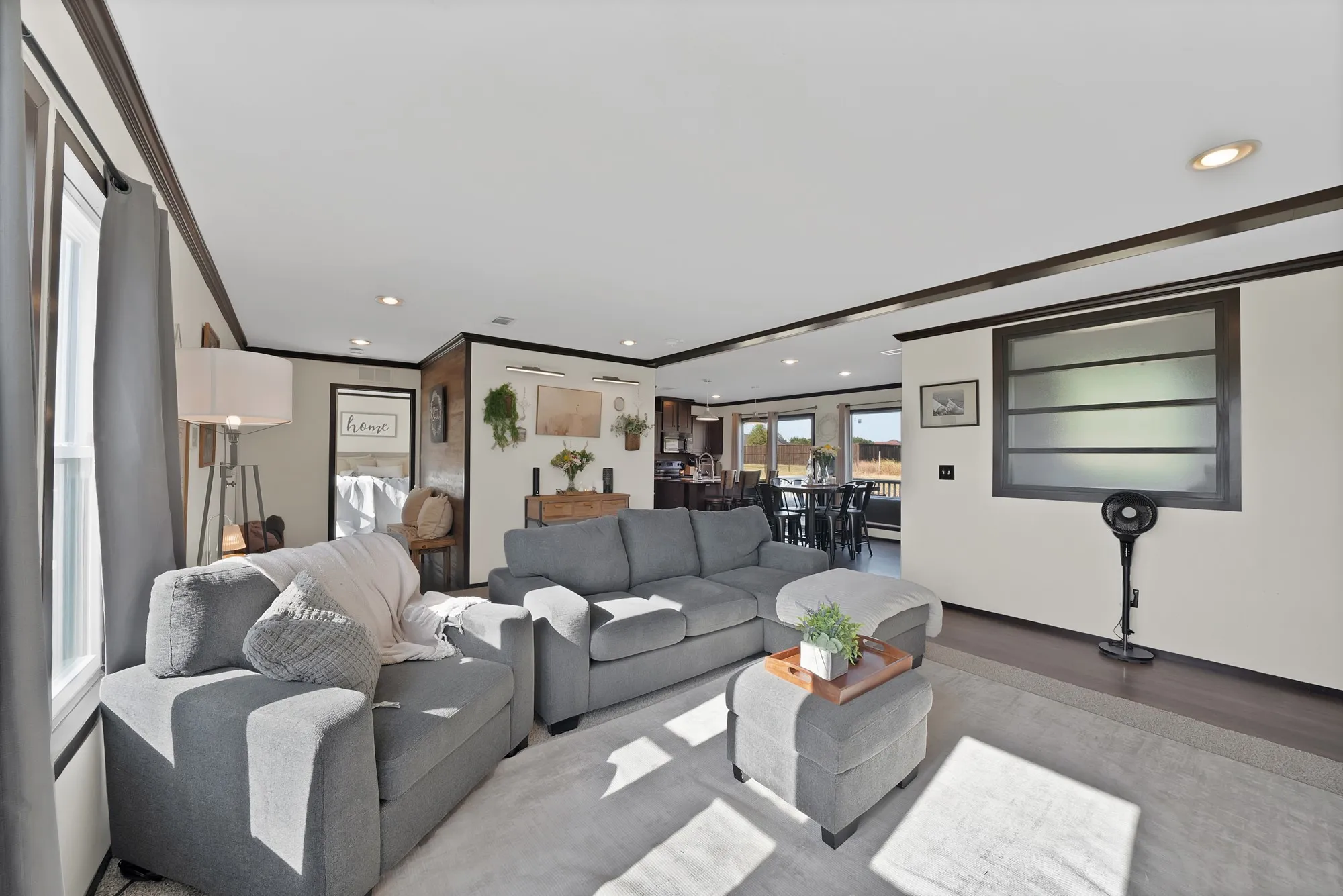 Recessed lighting, crown molding, dark wood-finish trim, and light wall finishes