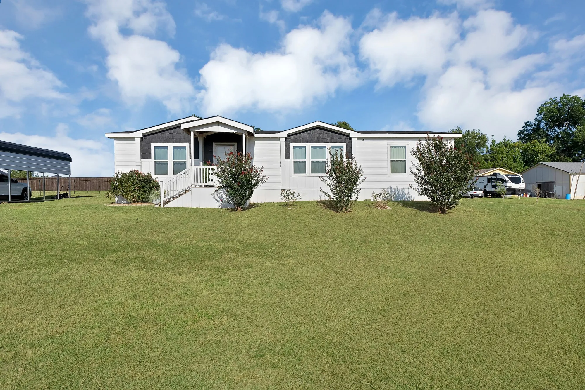 Single-story residence with a covered front porch and white railings