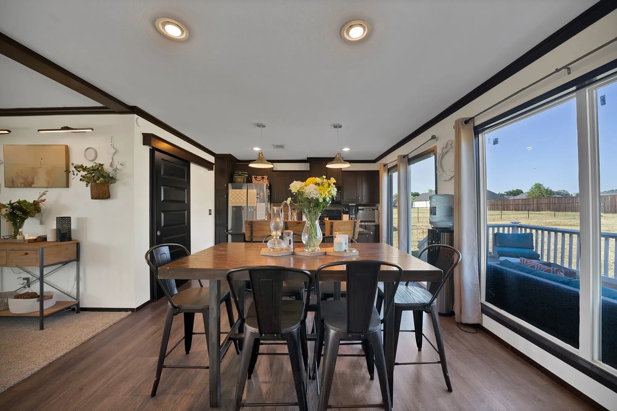 Wood-finish flooring throughout, with recessed lighting and dark trim details