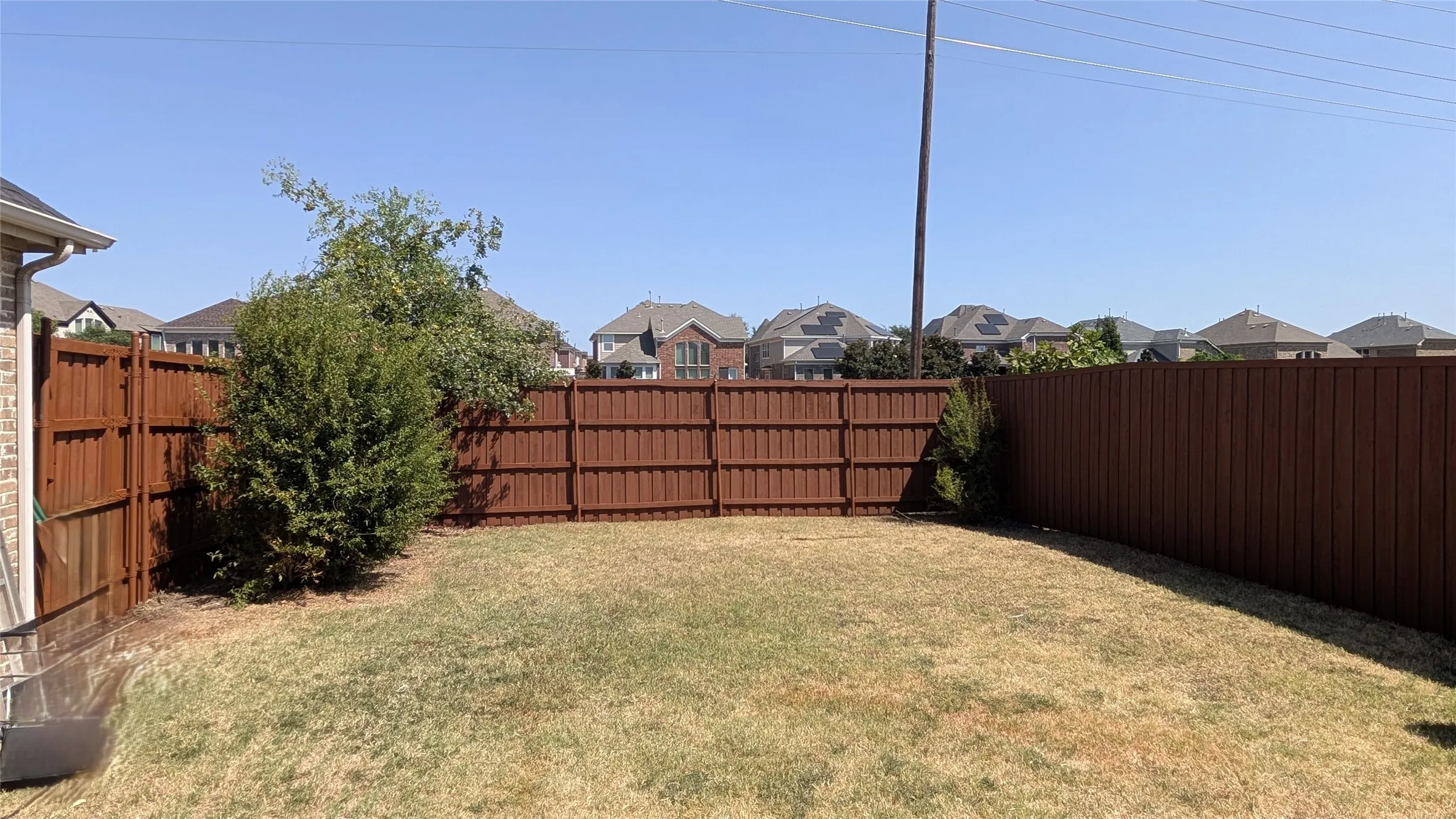 Private backyard featuring a full perimeter wood fence