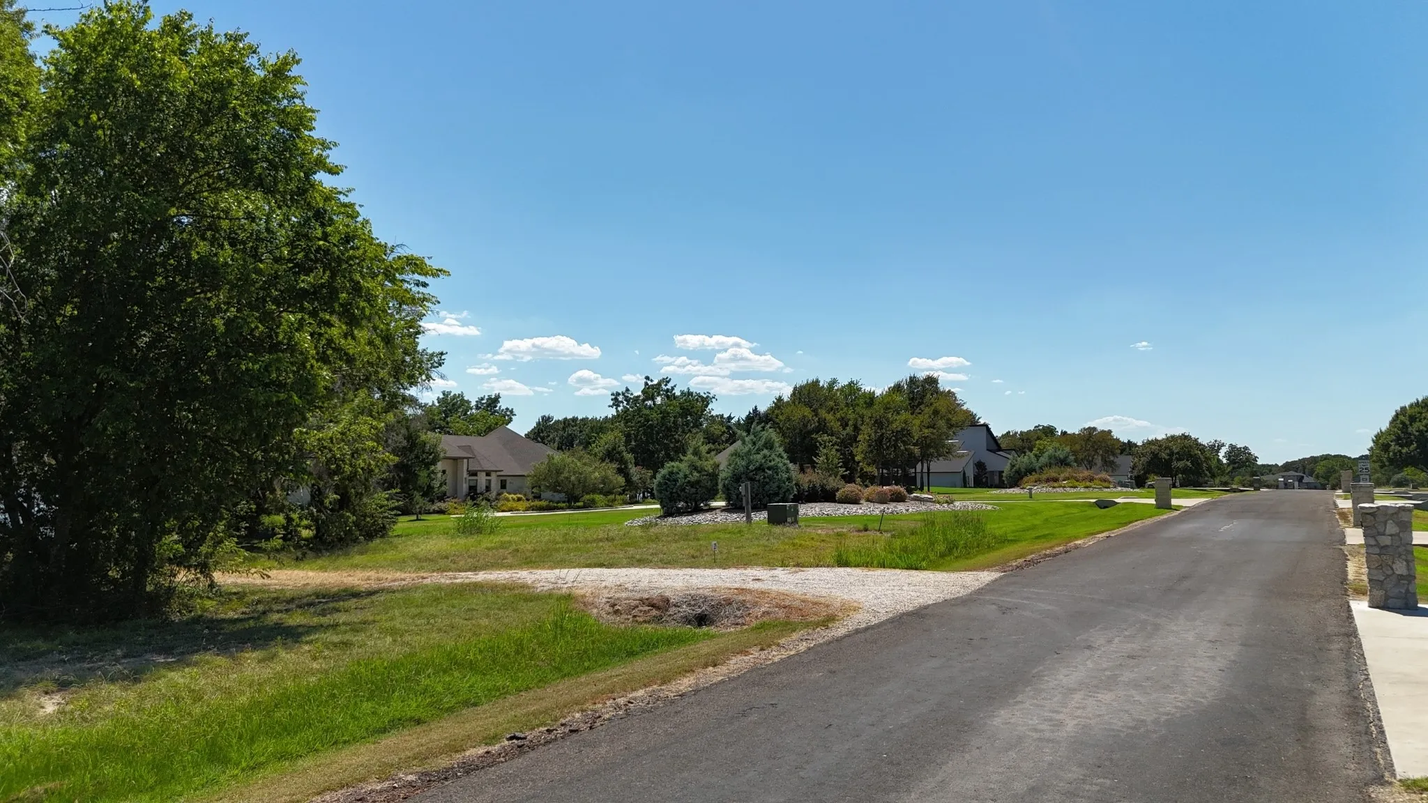 Peaceful paved-road setting and mature trees make this Central Texas lakefront lot an appealing location for a future vacation home.