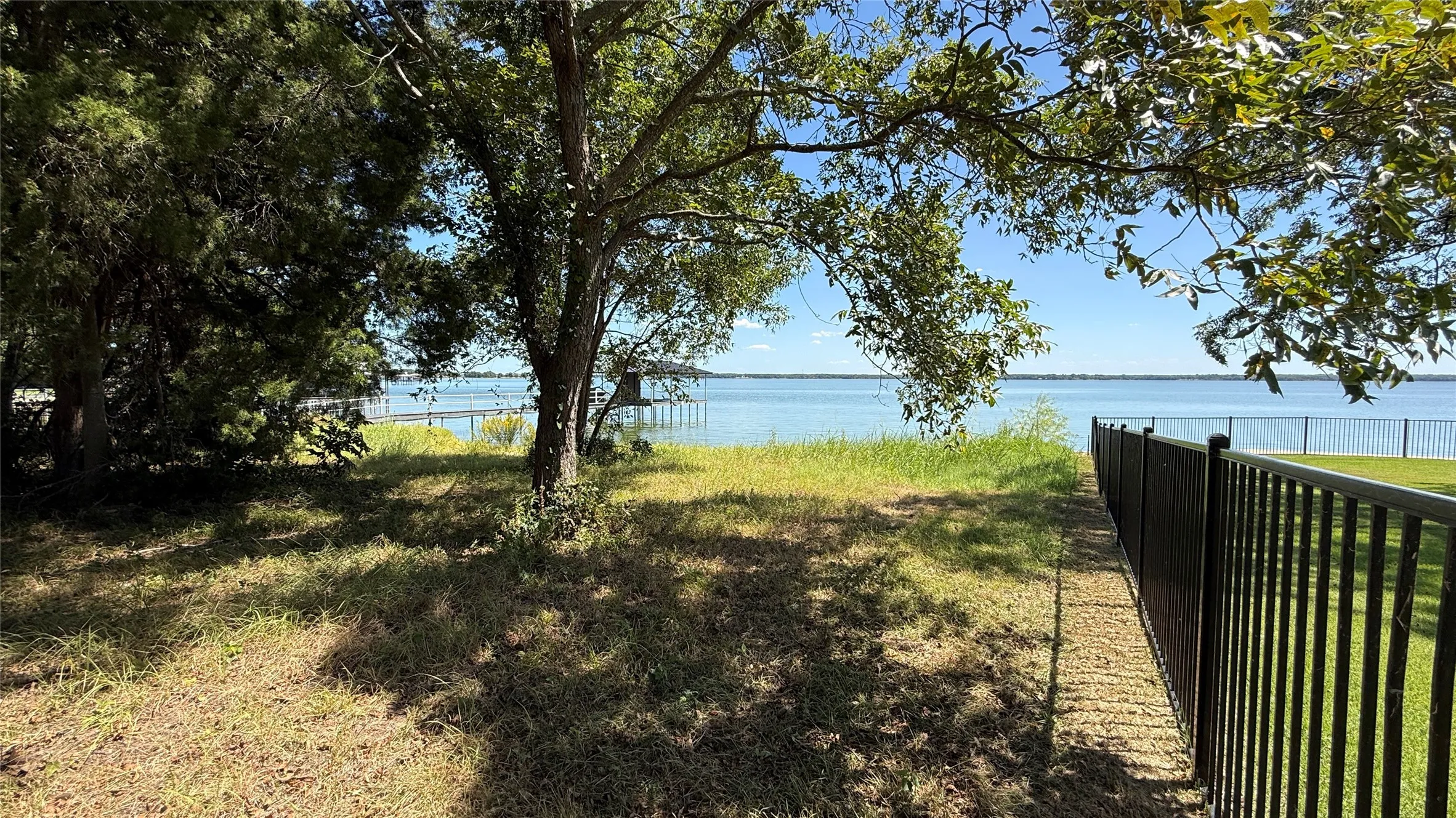 Mature trees and a scenic waterfront setting create an appealing Central Texas homesite for a vacation or seasonal residence.