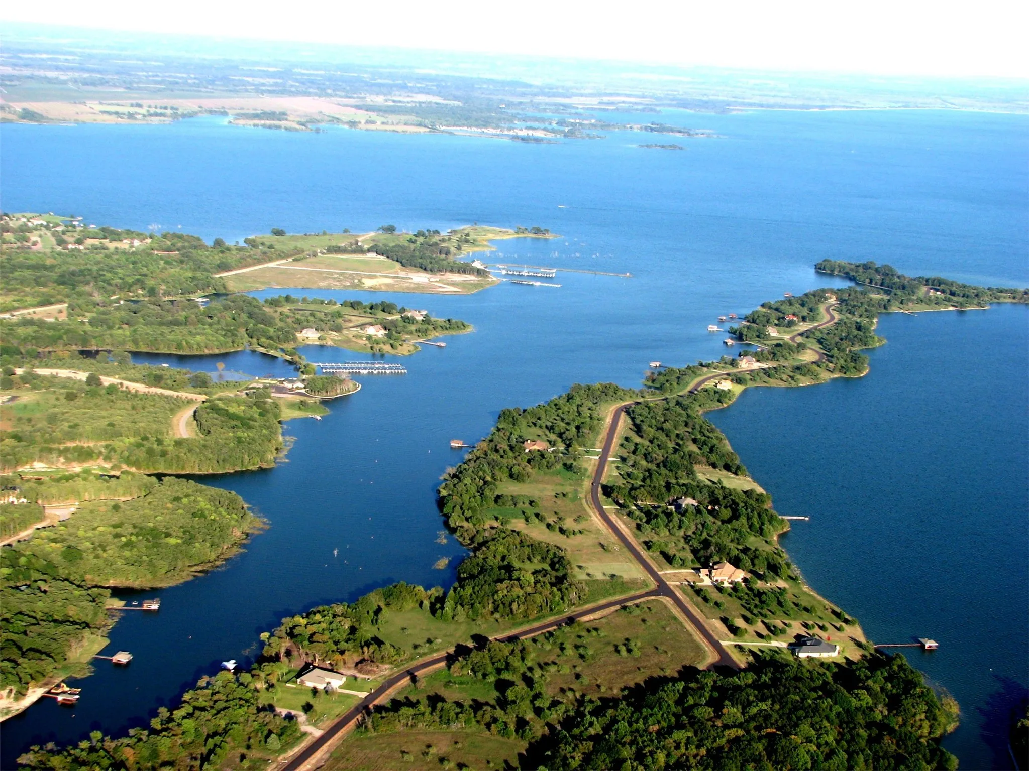 Tree-covered grounds and lake views create a private setting for a Navarro County second home or seasonal waterfront retreat.