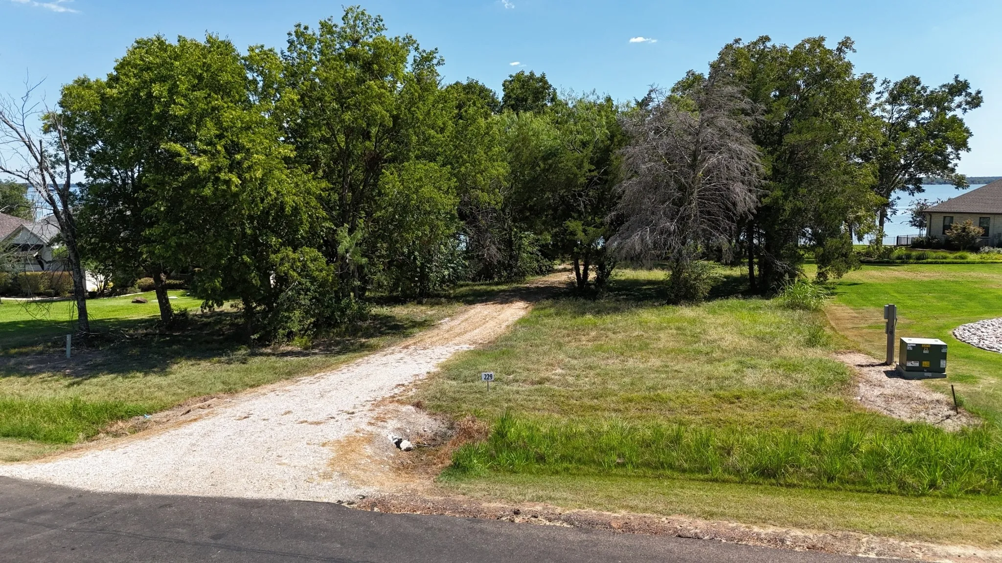 Mature trees and a scenic waterfront setting create an appealing Central Texas homesite for a vacation or seasonal residence.