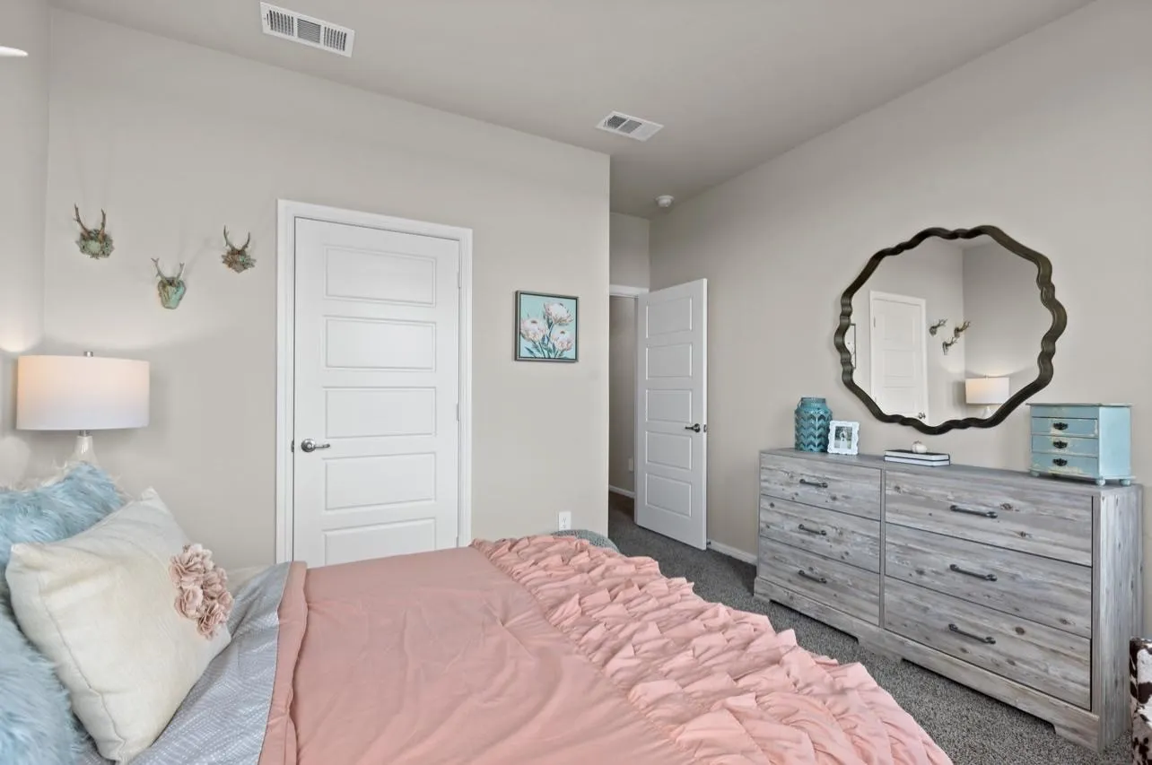 Carpeted bedroom featuring baseboards