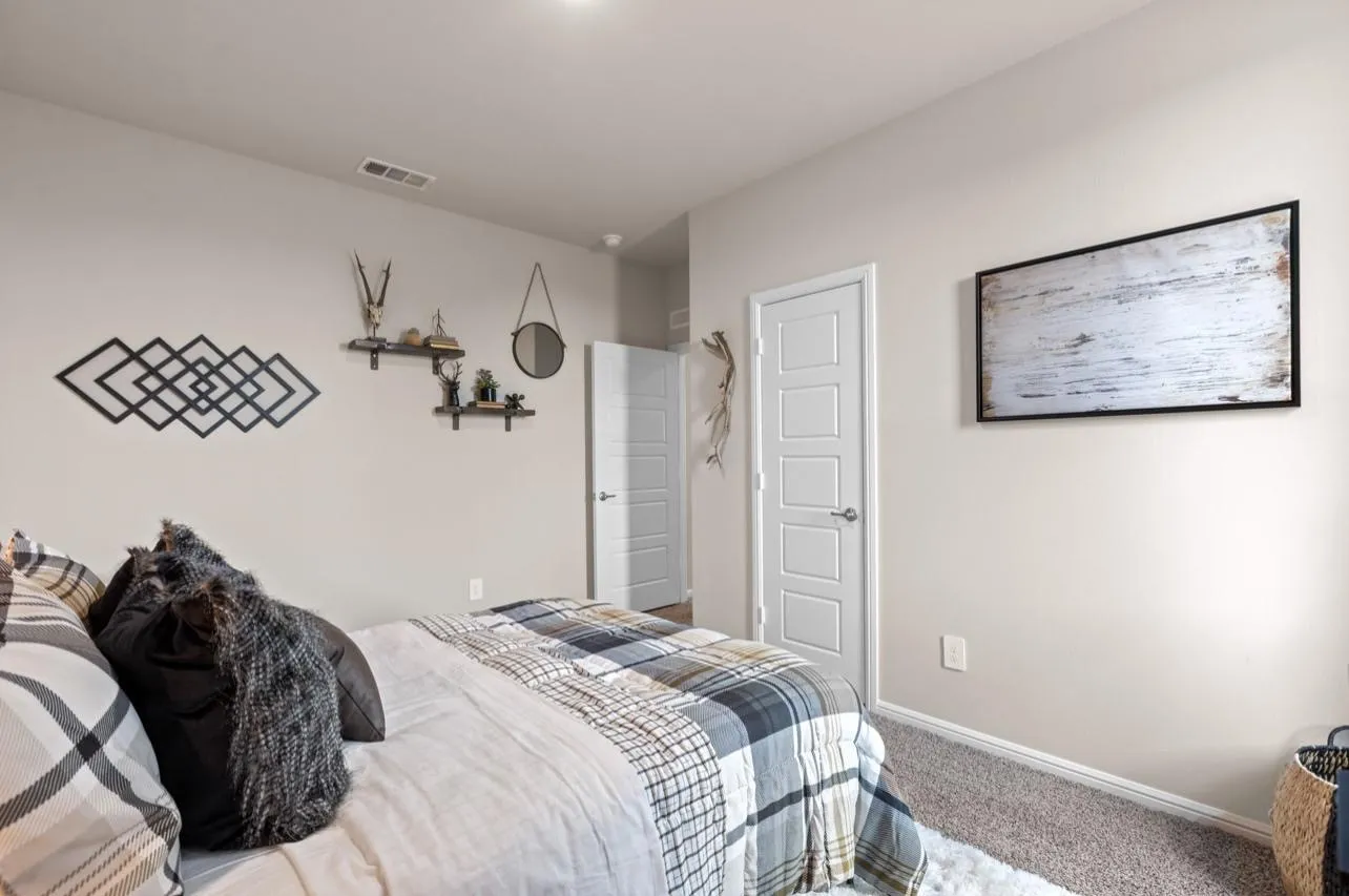 Carpeted bedroom featuring baseboards