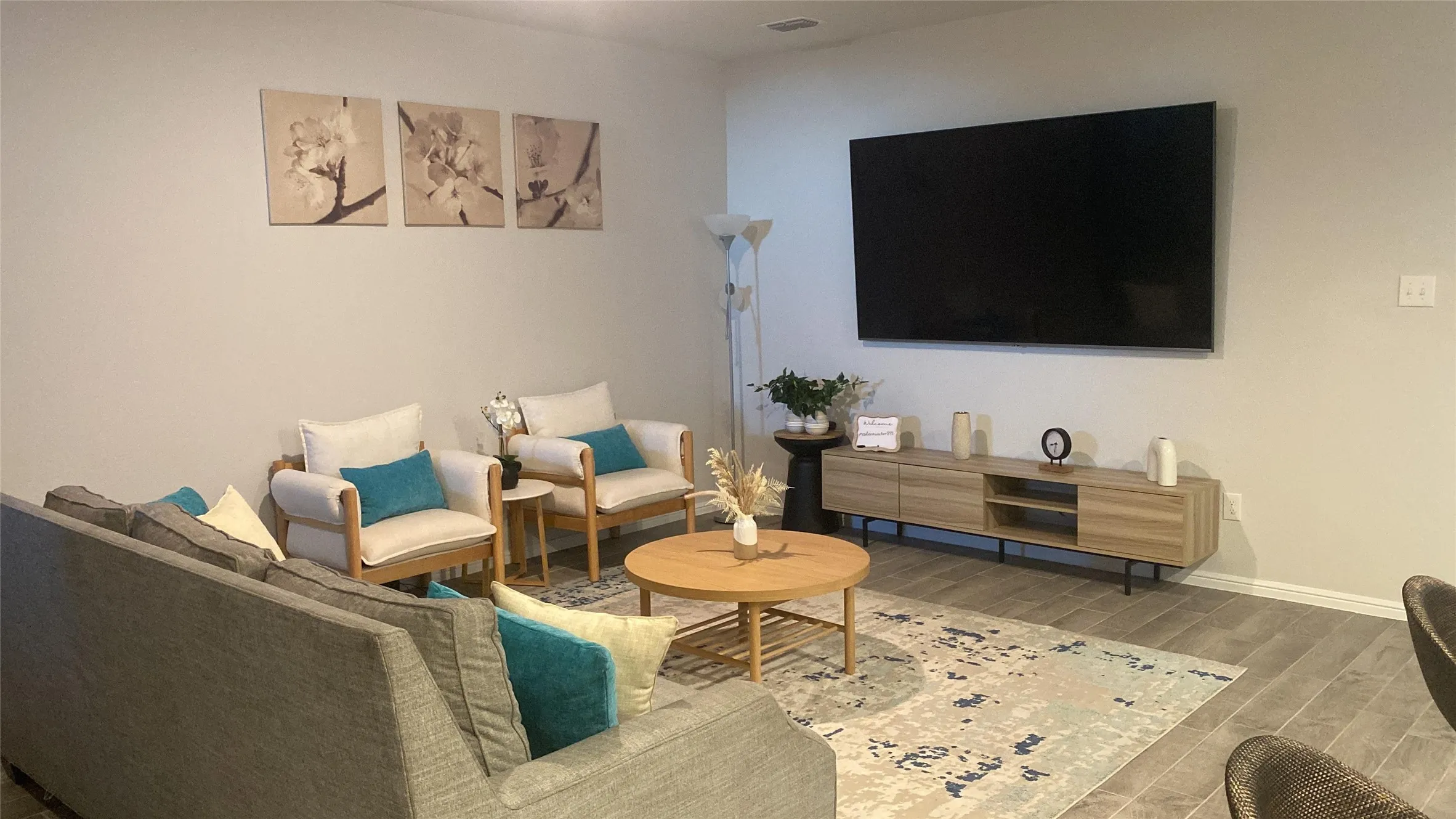 Living area featuring baseboards and wood finished floors