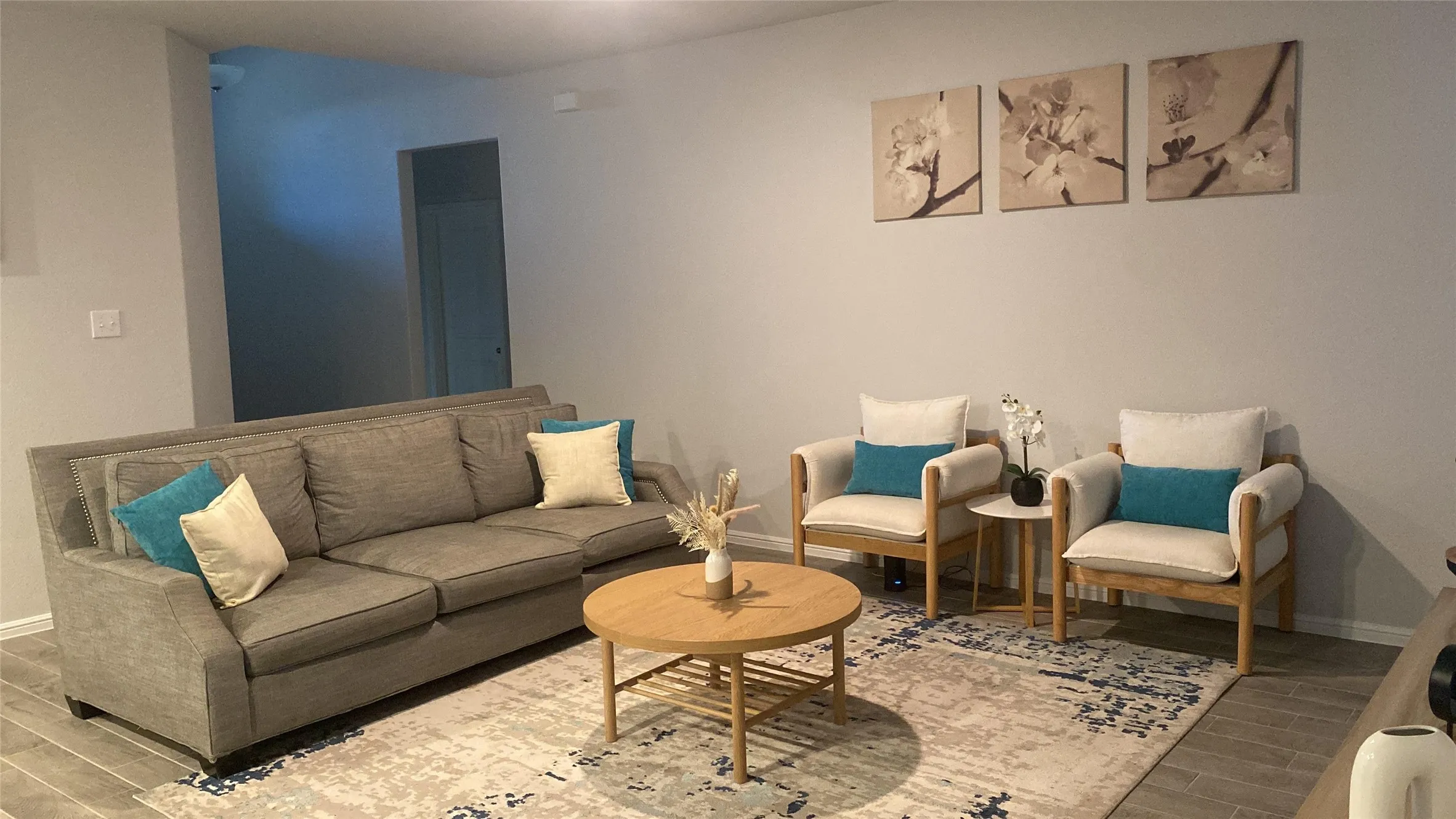 Living area featuring wood tiled floors and baseboards