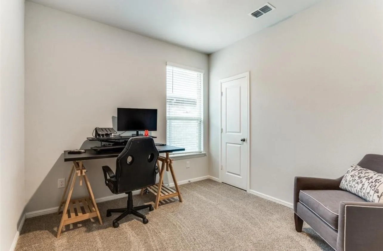 Office featuring healthy amount of natural light and carpet flooring