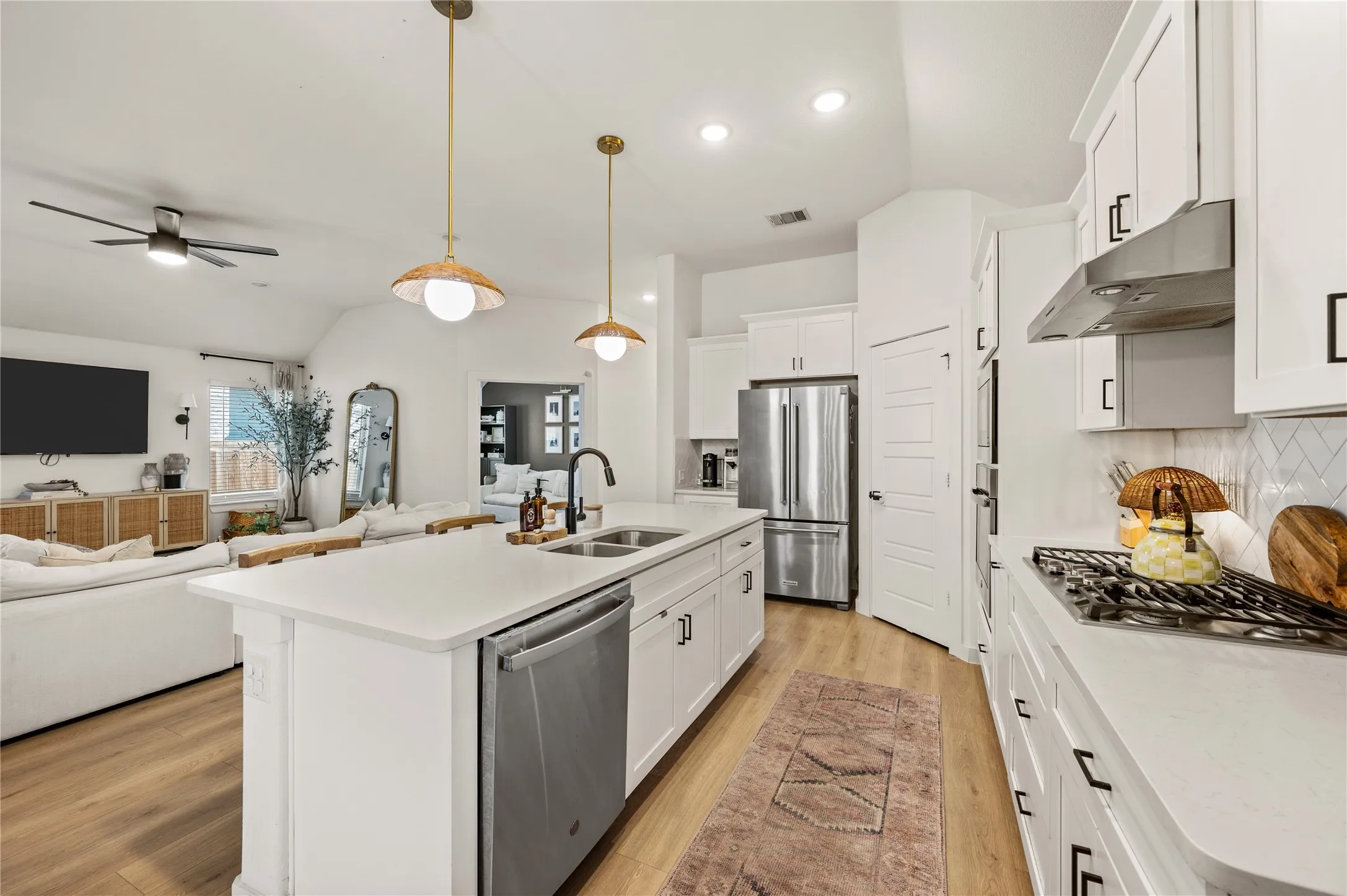 LVP. Updated pendant lighting. Neutral paint. Spacious island. Gas stovetop. Microwave and oven.