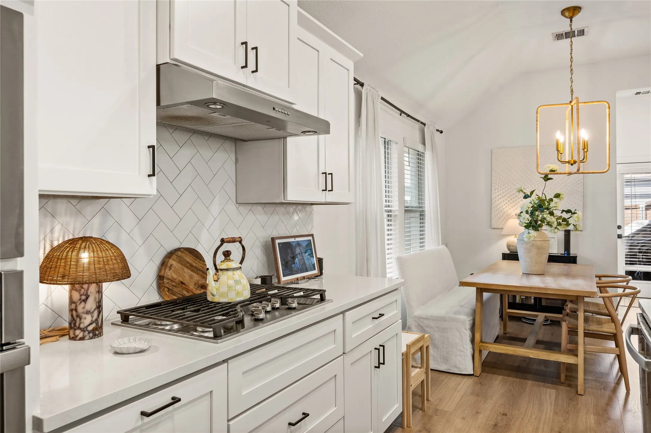 LVP. Updated pendant lighting. Neutral paint. Spacious island. Gas stovetop. Microwave and oven.