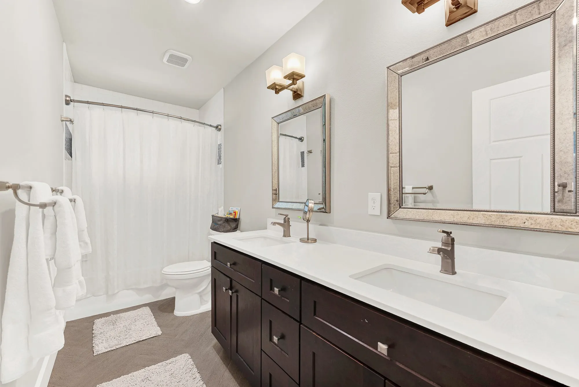 Double vanity with integrated rectangular sinks and white countertops