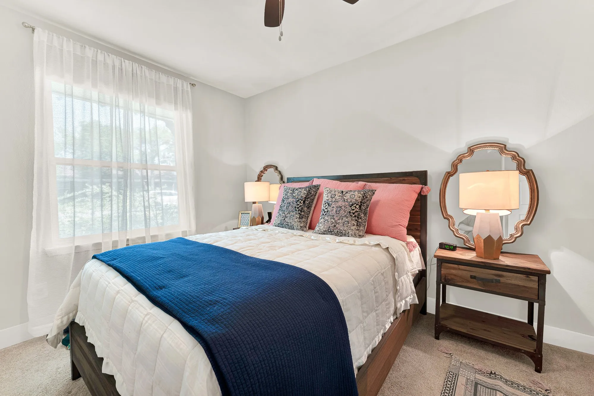 Recessed lighting, ceiling fan, window with sheer curtains, wood-finish flooring, and light-colored walls