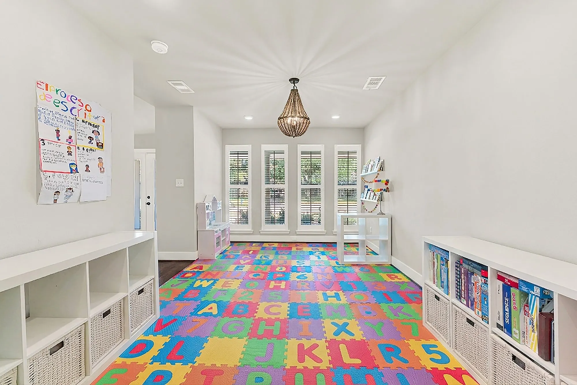 Set as playroom, Recessed lighting, wood-finish flooring, white walls, built-in shelving, and a decorative chandelier