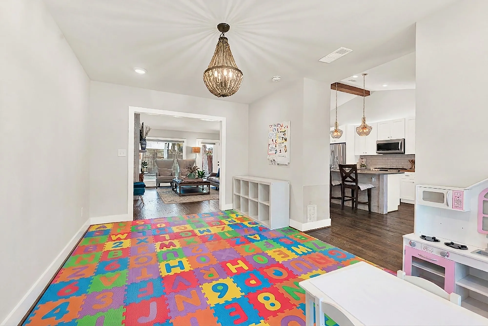 Set as playroom, Recessed lighting, wood-finish flooring, and a decorative chandelier