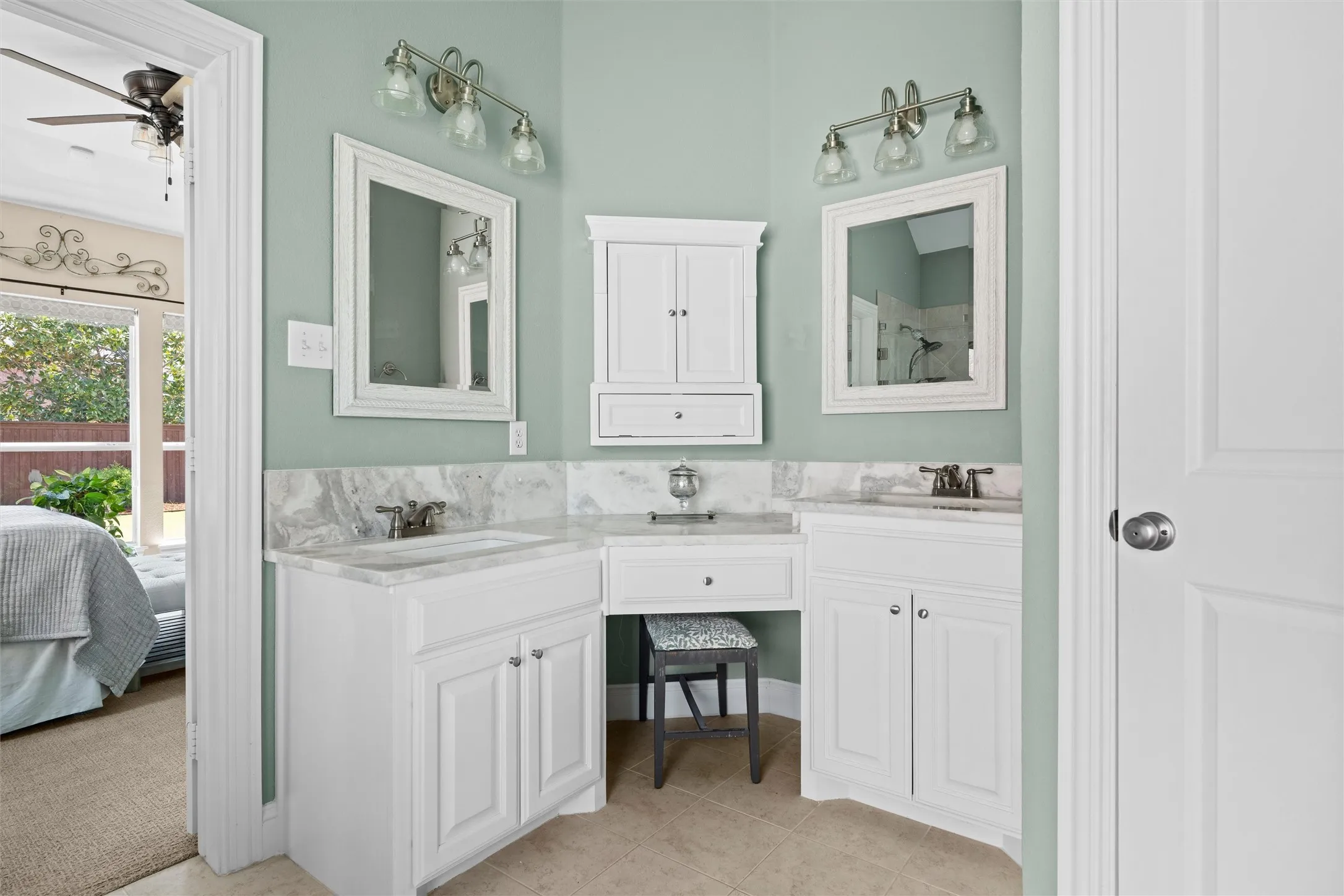 Dual vanity with white cabinetry, integrated sinks, and polished chrome fixtures