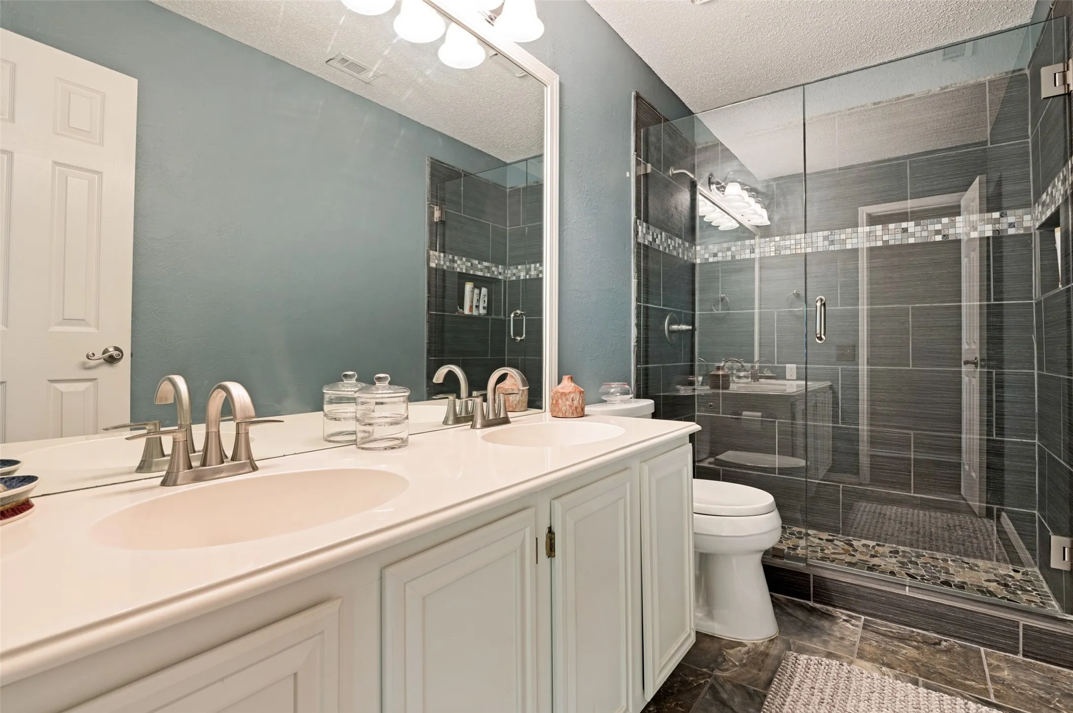 Dual vanity with white cabinetry and integrated sinks