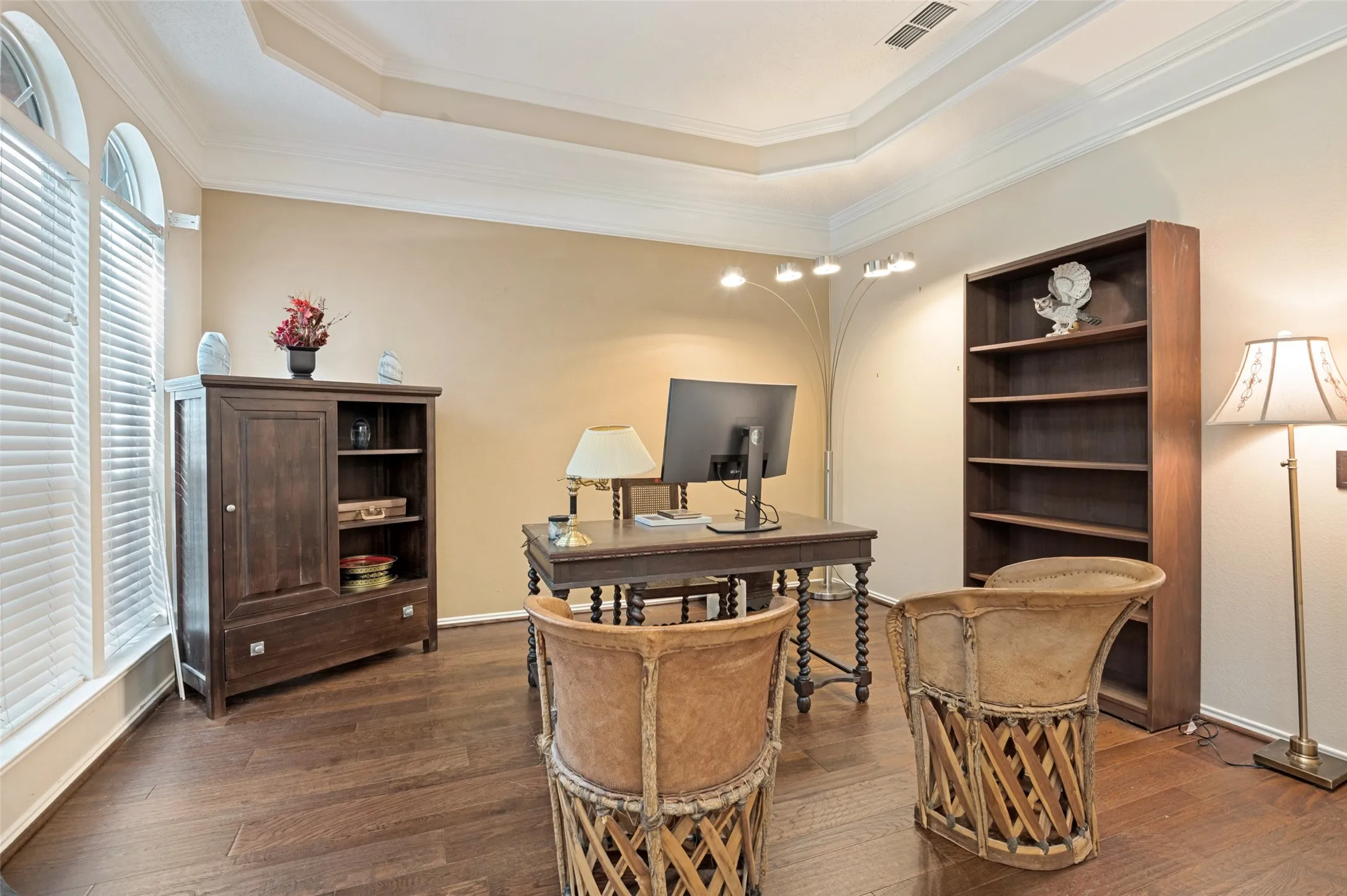 Front Office with crown molding, wood-finish flooring, and arched windows