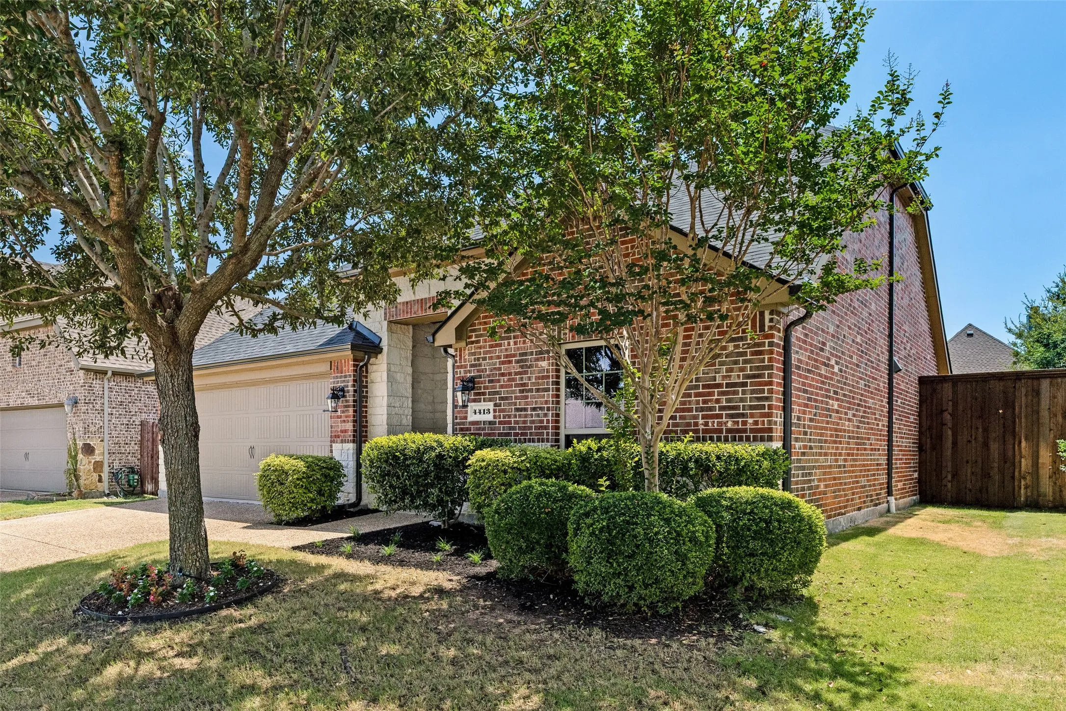 Brick exterior with a gabled roof and attached garage
