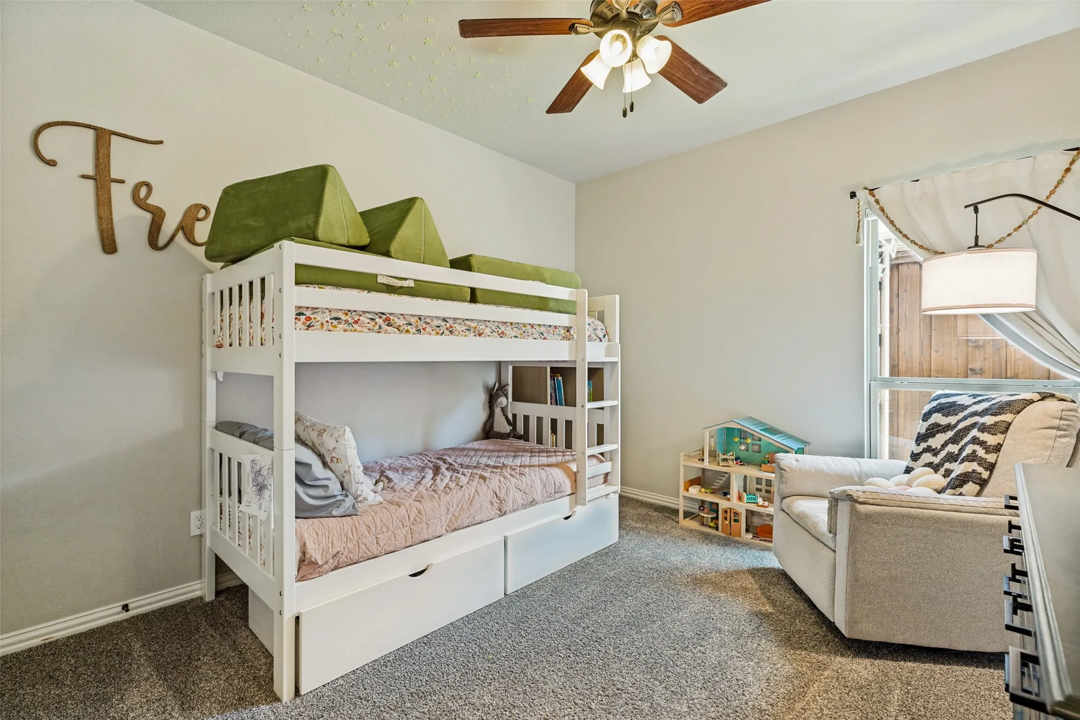 Carpeted room with a ceiling fan, a window, and light-toned walls