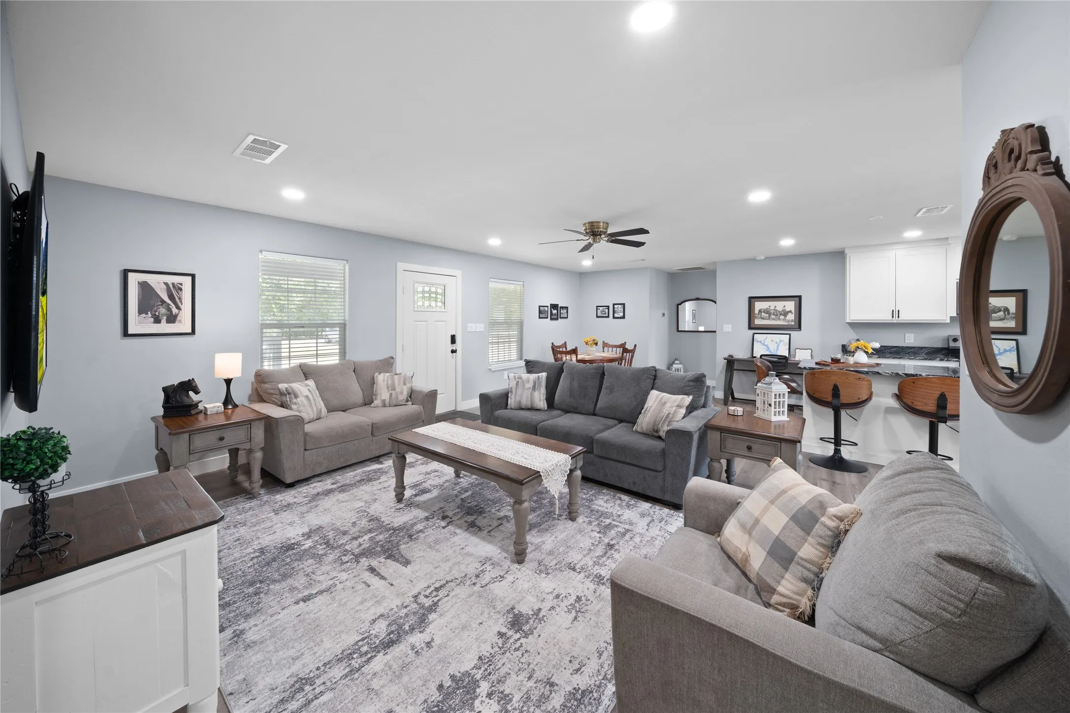 Open-concept living area featuring recessed lighting, a ceiling fan, and wood-finish flooring