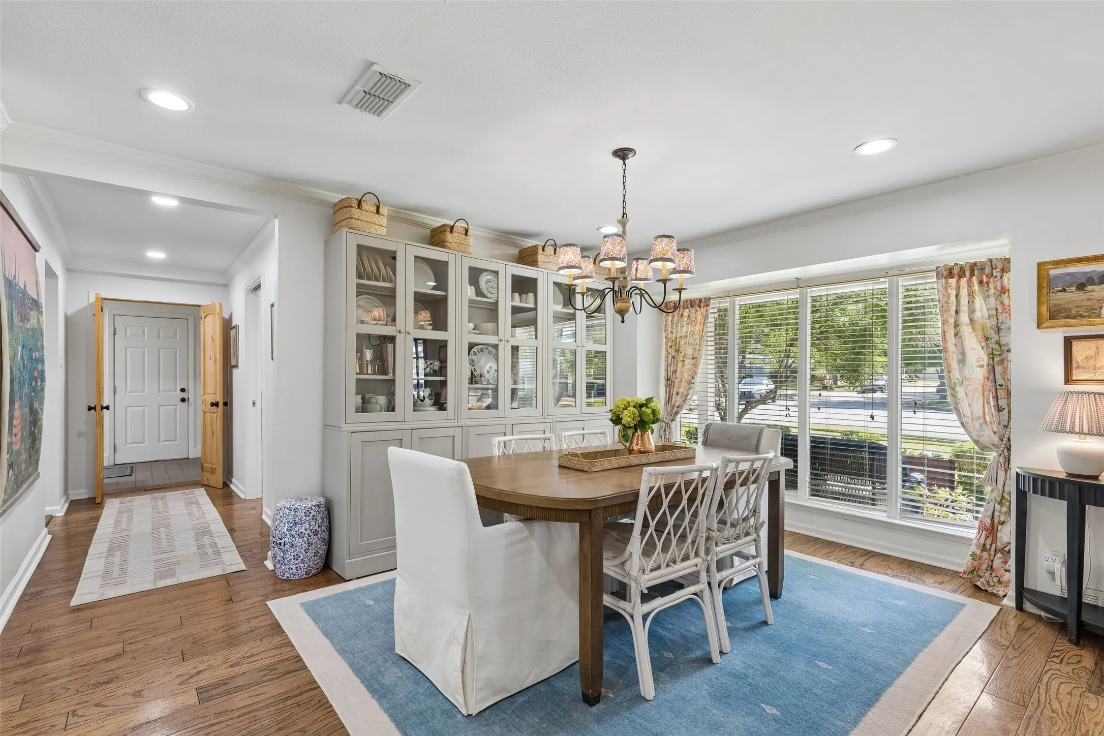 Dining room with abundant light and chandelier.